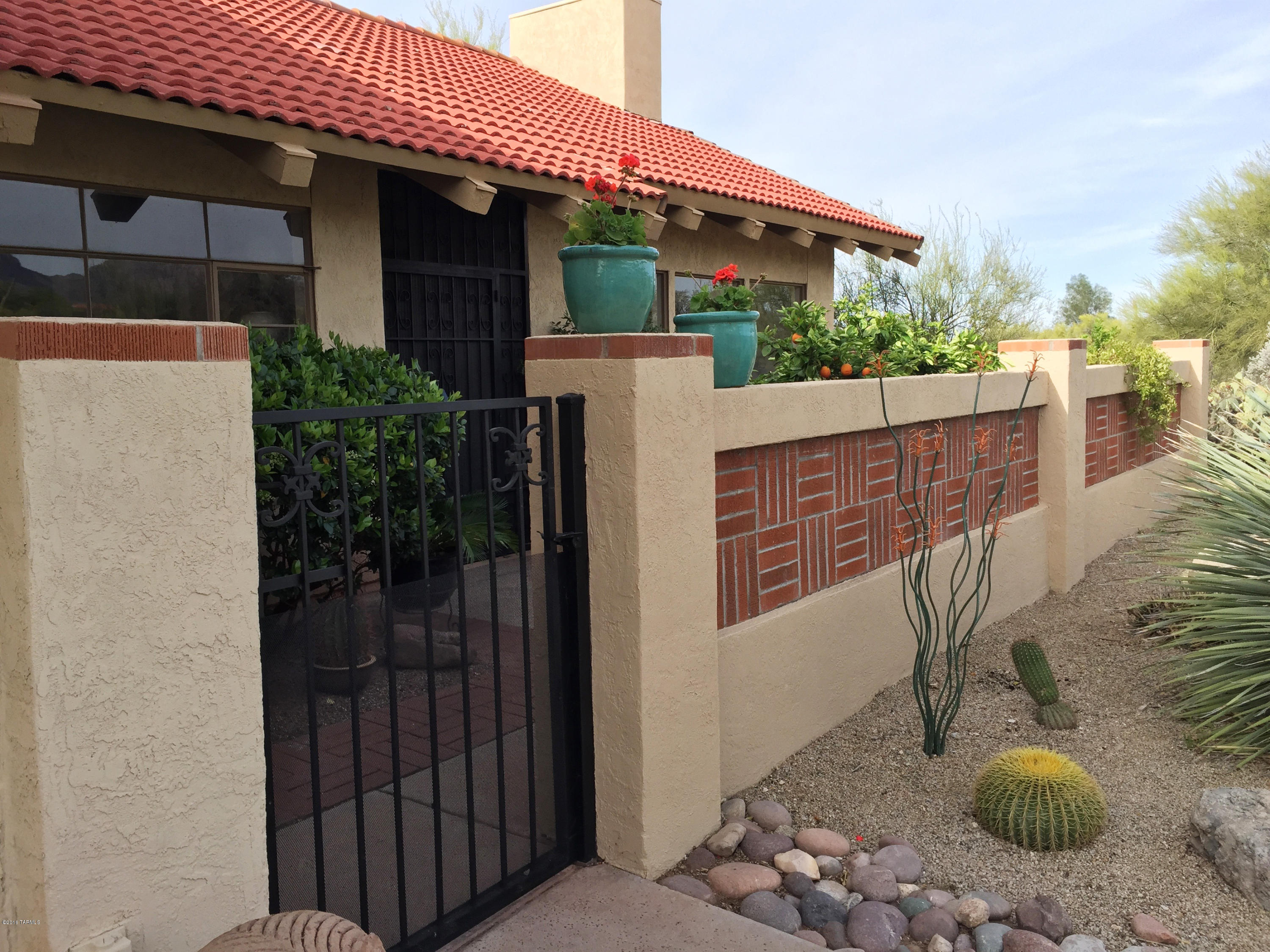 Stunning and dramatic w/vaulted ceilings and open beams. Wall of windows looking out on pristine desert & huge, sweeping Catalina Mountain views. End unit feels like a single family home on acres. Open, contemporary feel. Complete remodel of kitchen & bathrooms w/custom alder cabinets, granite counters, SS appliances. Bathroom has executive height sinks and large walk-in shower. Soft natural light throughout home. Large master opens to ramada and pebble tek pool. Besides den, there is a separate office completely decked out with custom alder built-in desk and cabinets. The best in desert living. Easy lock & leave. Owners are licensed to sell real estate in Arizona.