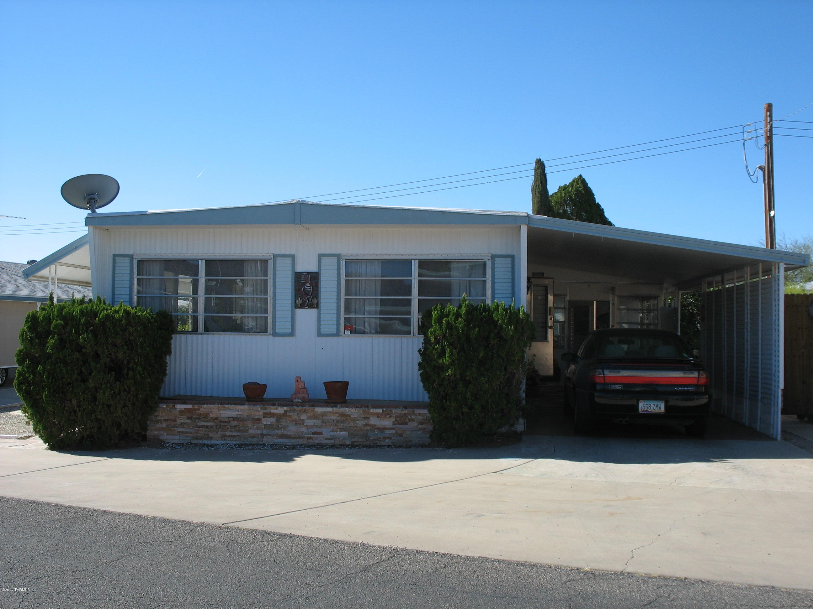 Vintage home with lots of color and many upgrades!  North facing home is close to all the amenities with great mountain views.  The A/C and furnace were installed in 2016.  Kitchen/dining is open to the living room.  Porch and patio on the east side.  Large AZ room on the west side which can be used as an extra bedroom, laundry, craft room, etc. and has access from the guest bedroom.  The HOA fee includes unlimited golf, tennis, pickle ball, shuffleboard, 3 pools, spa, exercise room, trash collection, and a lot more.  You own the land!