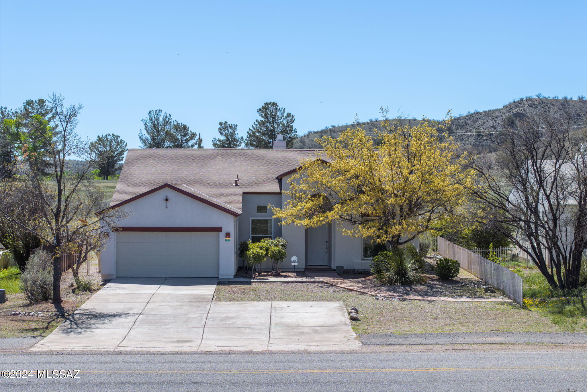 This exceptional three-bedroom/two-bathroom home is located on a premier +/-0.26 acre lot in coveted Kino Springs! The immaculate interior boasts soaring vaulted ceilings, an office/den area, a large great room, a separate living room, a formal dining area, canned lighting, built-in shelving, a fireplace, bay windows, dual vanities, walk-in closets, a spa style tub with separate  walk-in shower,  laundry room with utility sink, a two-car garage, new windows, an intercom system, and remarkable views from every room! The large, premier stainless-steel appliances, granite countertops, a pantry, a breakfast bar, and an ample breakfast area. The exterior features a recently refinished roof, enormous concrete driveway, covered front entryway, gravel landscaping, ...see more.... ....an elongated back patio, concrete pavers, a fire pit, established vegetation with irrigation, iron fencing, and remarkable views of the surrounding valley countryside! This home highlights pride of ownership at its finest!