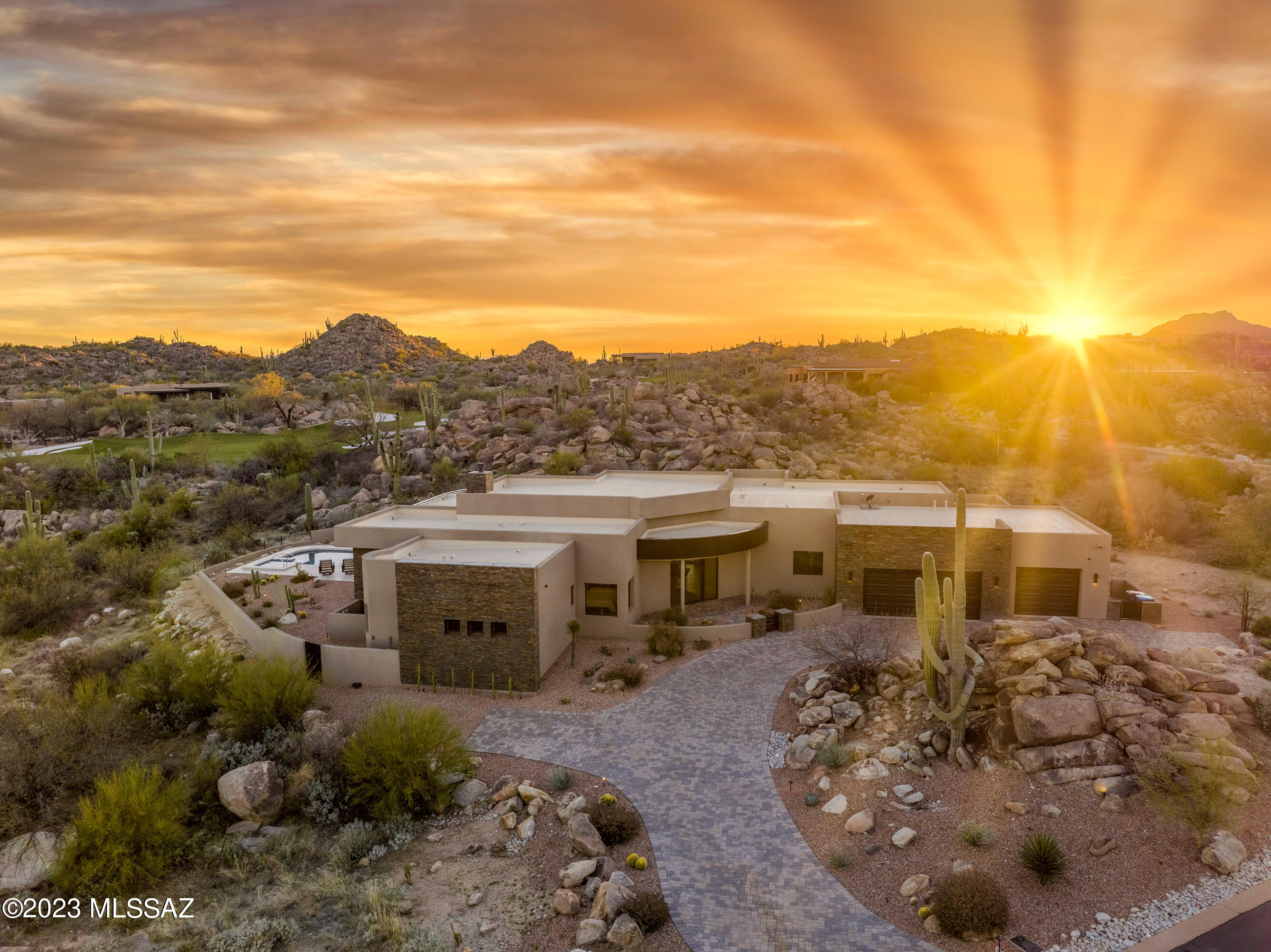 Rock Outcroppings, Saguaros, Mountain Views, Golf Court Lot and a beautifully designed home in the extraordinary Stone Canyon Development. Large open spaces as you arrive into the great room with stacked stone gas fireplace and floor to ceiling glass. Kitchen provides wolf and subzero appliances. The outdoor domain is open and spacious with an abundance of covered patio and decking for year round lounging around the pool and spa.  Be done with the typical stucco and welcome a home exterior of eco friendly colored cork-spray. An innovative way to provide a protective coating that acts as a thermo blanket for your home in addition to adding higher efficiency, less color fading and little to no cracking. Split floor plan, each bedroom having ensuite bathrooms. Newly built in 2020 this