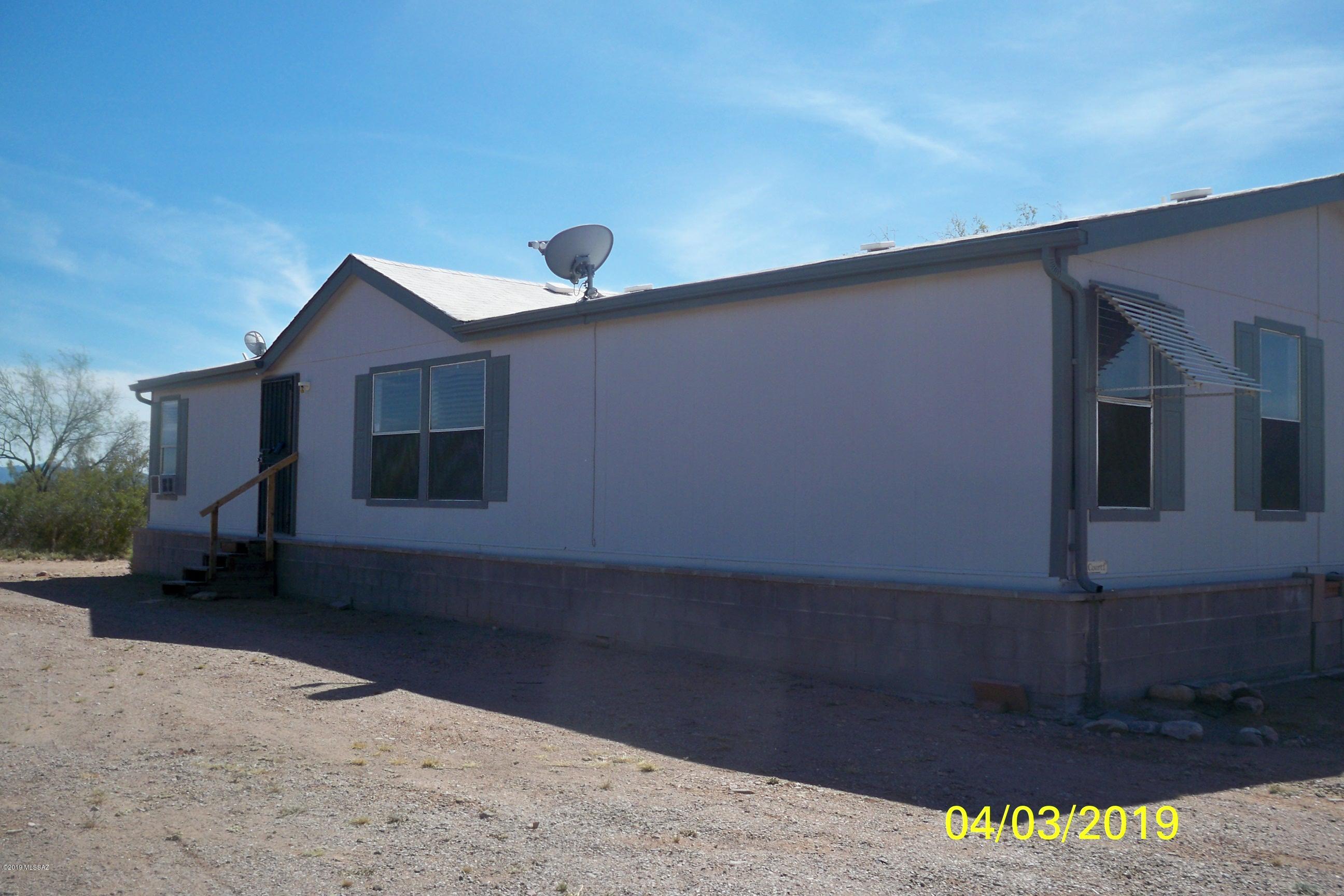 NOTE:  A FIRST LOOK PERIOD IS IN EFFECT FOR ALL TYPES OF BUYERS, BOTH OWNER OCCUPANT BUYERS AND INVESTOR BUYERS.  THE SELLER REQUIRE 8 DAYS OF EXPOSURE IN THE MLS BEFORE RESPONDING TO ANY OFFERS AND THE SELLER ADHERES STRICTLY TO THIS TIME FRAME.   Nice double wide CAVCO manufactured home featuring a 3 bedroom/2 bath floor plan.  Open spacious living room dining area and a large deck in the rear.  This 4 plus acre lot offer plenty of privacy, mountain views and beautiful sunsets!    This is horse property with some facilities.  Yes,  this property needs some work and upgrades in order to bring it up to par and make it shine again!