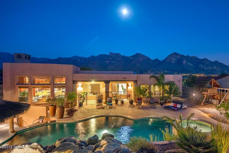 Beautiful 4BR/3BA in gated Pusch Ridge Vistas. Fabulous views and truly amazing resort backyard featuring dramatic waterfall, pool/spa with swim-up bar, cabana with grill, fridge, ice maker, beer tap and flat screen TV. Just imagine the family fun, parties and happy hours. Gourmet kitchen features Viking Double oven and 5 burner gas range. Home theater in living room features 100 in. projection TV. Master suite with bamboo flooring also includes sitting area with cozy fireplace. Home must be seen to be fully appreciated, especially from the fire pit area overlooking the resort pool with unsurpassed Pusch Ridge views.