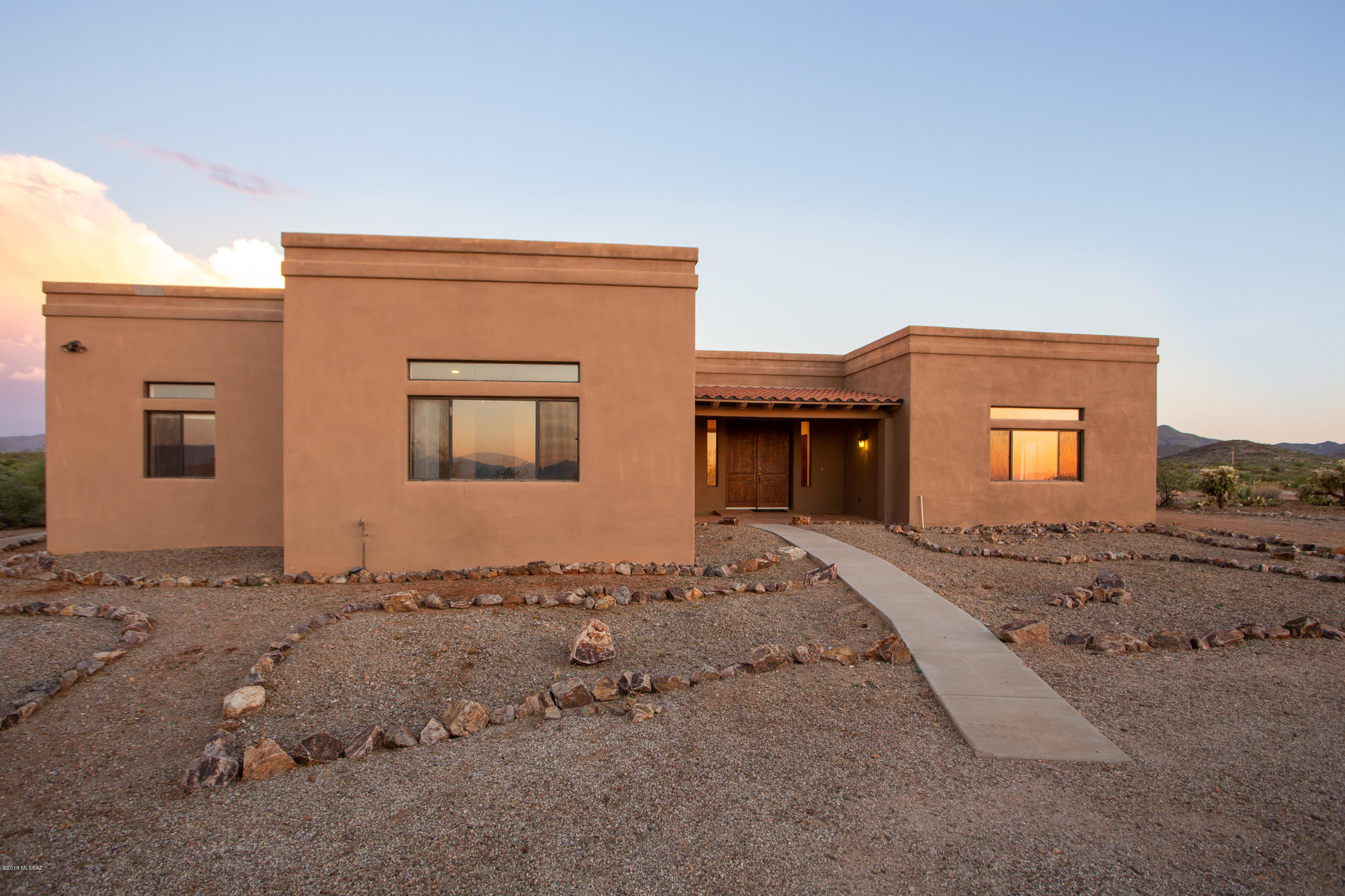 Beautiful custom home, 1-acre lot, located on a cul-de-sac in a lovely rural setting. Solid masonry construction with contemporary look, 9'5'' ceilings. The home features 3 bedrooms, 3 bathrooms, 2,609 square feet, large kitchen with breakfast bar, family room with fireplace and built-ins for your decor/storage, covered rear patio, 3-car garage, and laundry room. Tile floors and carpeted bedrooms. Located in the sought after Vail School District. Country with Panoramic Mountain views. Peaceful and quiet, and just a short drive to Tucson and I-10. Shopping, restaurants and many amenities only 20 minutes away. OWNER/SELLER