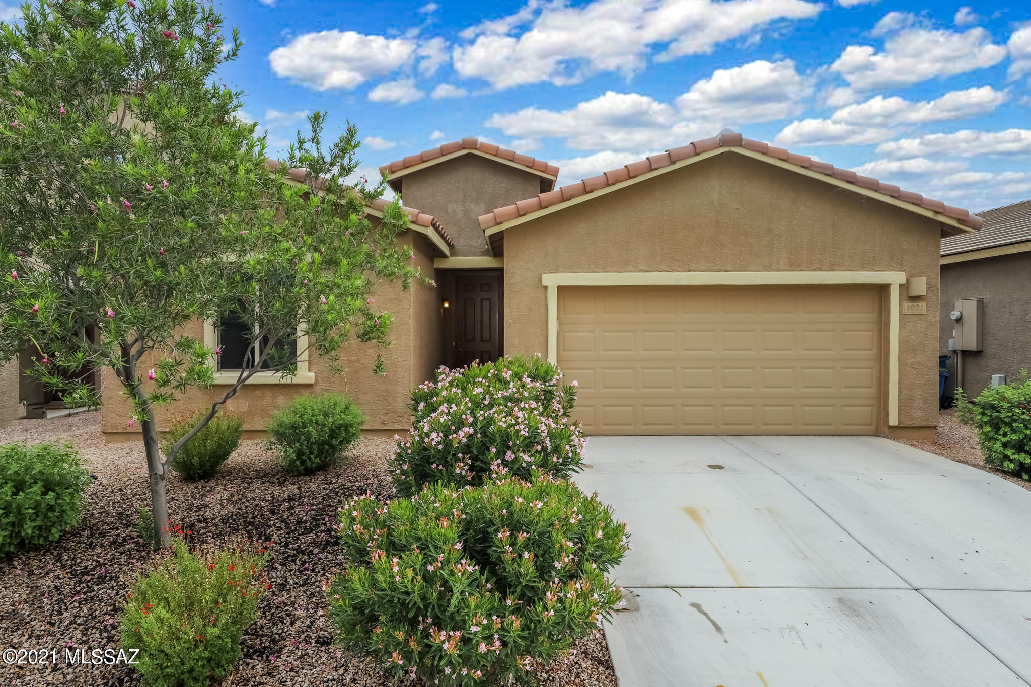 This beautiful home features a spacious kitchen w/ large center island, added  dry bar, backsplash, SS appliances and Granite countertops. Open to dining area and welcoming great room make this home an entertainers dream.  Formal Dining room converted into Flex Room with glass French doors.  Split floor plan features two guest bedrooms w/ full bathroom just off entry way and secluded master suite for added privacy.  All Rooms feature LED can lights as well as ceiling fans and blinds.   Extended garage offers plenty of storage, epoxy floors and upgraded LED Lighting.  Full wrap around porch with outdoor fans create additional living space making this home complete.