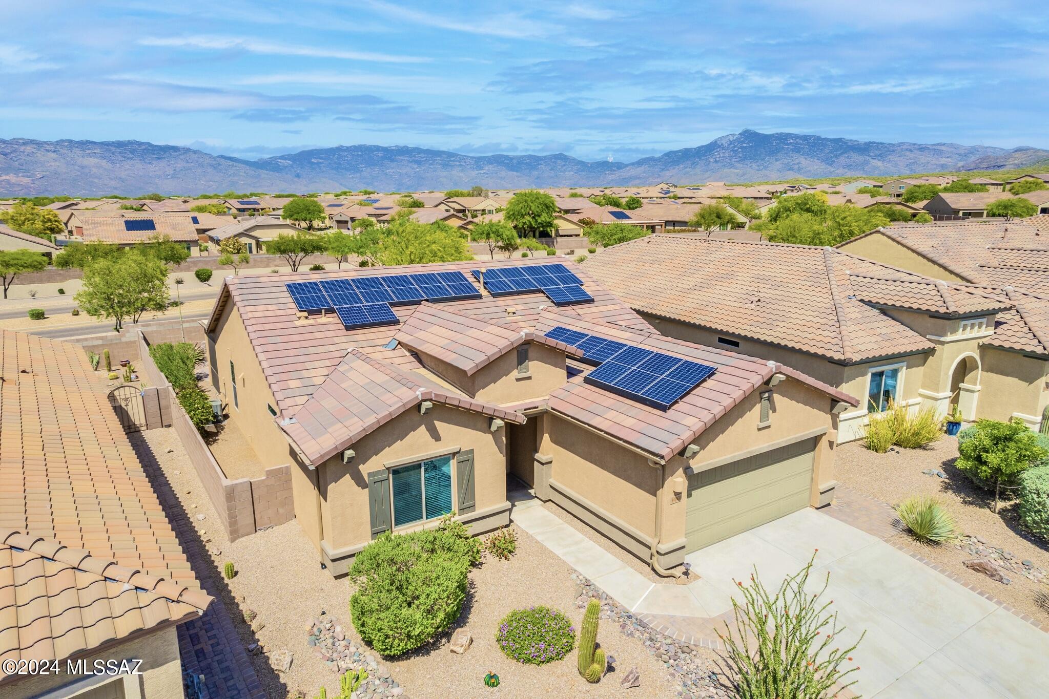 Northeast facing back yard with views of the Rincon Mountains. Freshly painted and well-maintained 2 bedroom PLUS DEN, Enchantment floor plan. Remote-controlled shades at patio. The open kitchen offers under cabinet lighting, newer oven/stove, newer microwave, newer dishwasher. This home has SOLAR panels, water filtration/soft water system, and tankless water heater. Updated carpet and pad. Refrigerator included!