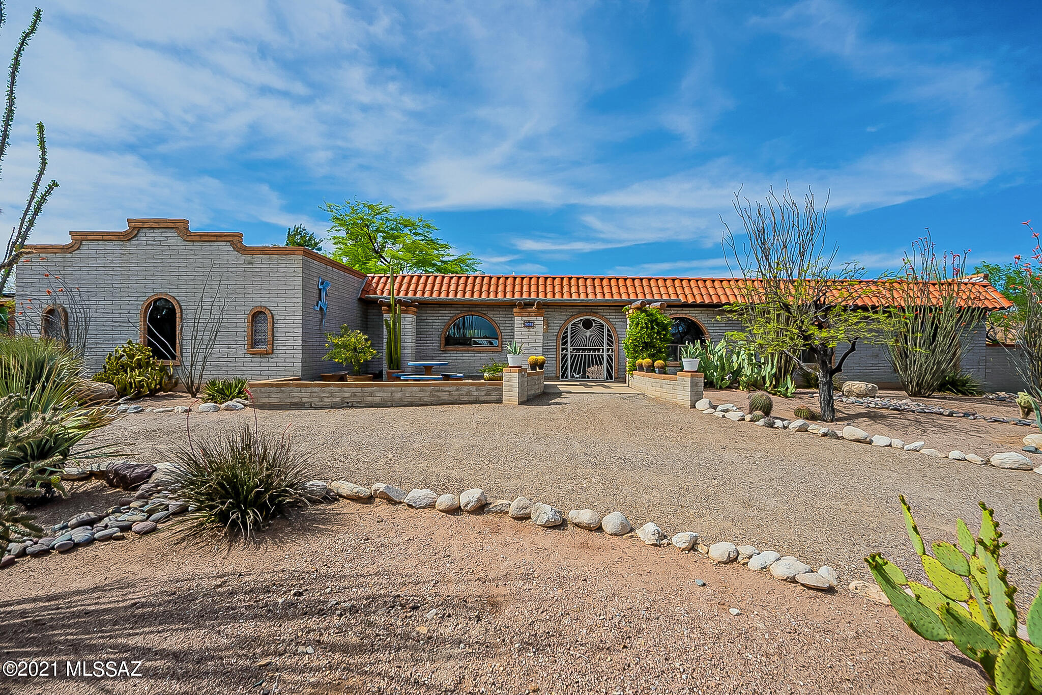 Beauty and comfort combine to create the ultimate desert living experience in this gorgeous foothills home!  Living area is open and spacious, featuring additional sunken library/media room with gas stone front fireplace. Kitchen has been updated with quartz countertops, stainless steel appliances and overhead hood. Master bedroom offers another gas fireplace and walk-in closet. North-facing backyard with stunning views of the Catalinas. Enjoy the sparkling pool with waterfall and gas fire pit.  Relax under the covered patio or in the mission-style side courtyard, complete with fountain. The Rincon and Santa Rita mountains and the twinkling of city lights can be enjoyed from the front patio. Extended-length garage and attached workshop area offers additional storage and flexibility.