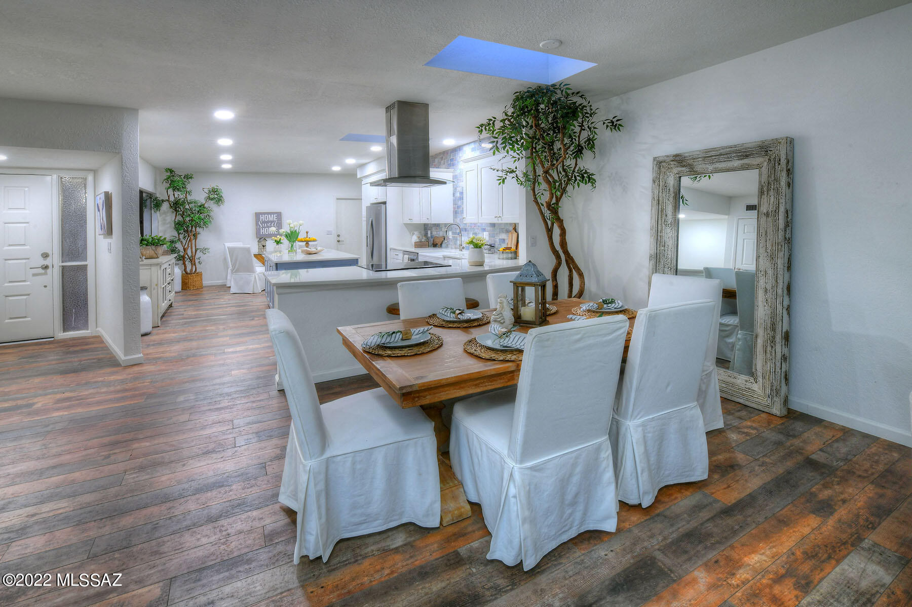 Fabulous price, Fabulous home.  The kind of home that invites the outside in at every turn.   Whisper White accented by a fabulous color called ''Stormy Skies'' creates an airy light ambiance.  Love the full length covered patio  with nothing behind.  Such a peaceful spot.  
Open kitchen with custom cabinets, island, and a breakfast bar that is so versatile....  drinks?  Perhaps set out a buffet for your patio dining ? and my personal favorite... sitting and supervising the chef!  The bathrooms echo the crisp color tones.  I know this home is in the heart of the desert but somehow I feel like it is a personal oasis.