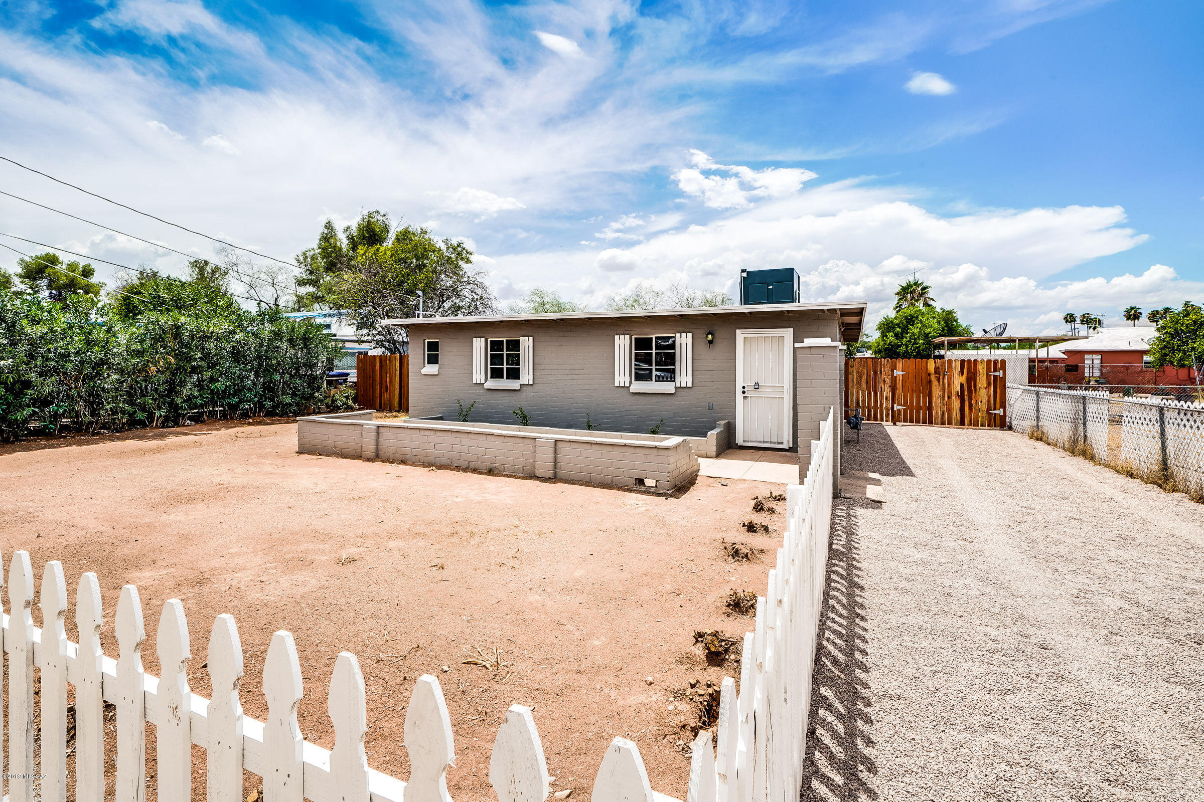 Range priced $125,000-$135,00! Oh so cute! Nice remodeled central home complete with a white picket fence. New kitchen with granite counter tops, concrete floors, updated bathroom with custom tile surrounds in the shower. Two spacious bedrooms, north bedroom has mountain views. Great yards front and back. There is a double gate entry to the back yard and all of this on a .19 acre R2 lot. Perfect, affordable home. Own for less than rent.