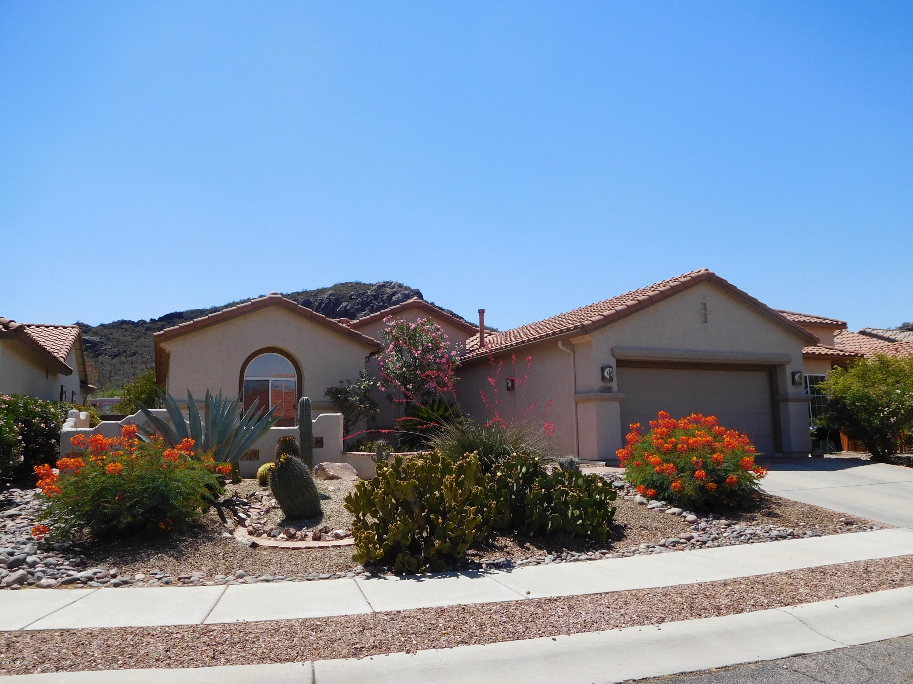 MOUNTAIN & SUNSET VIEWS from living room, kitchen, backyard patio & Arizona Room. Welcome to Sunflower active adult community that offers planned activities, physical fitness work-out room, rec center, year-round swimming and quiet neighbors from throughout the United States who enjoy living in a dream location that mirrors a resort.  This beautiful home is 2bed/2bath PLUS DEN, clean and move in ready.  The master is spacious, garden tub/shower, walk-in closet.  Soft water, storage in garage attic.  Refrigerator plus W/D included in sale.  If you are over 50, this sought after community offers clubs & activities for every taste or hobby.