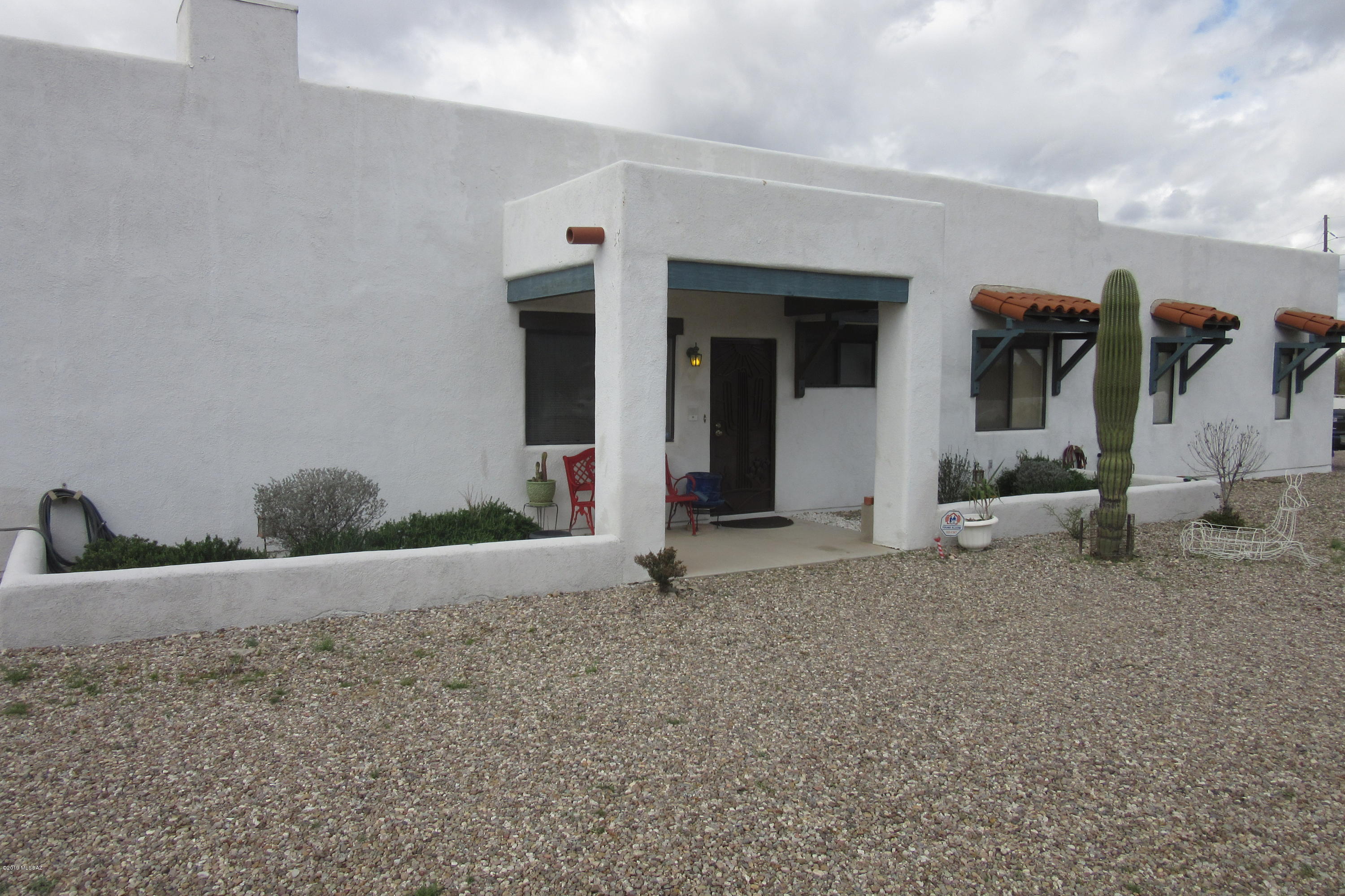 Mtn. views in three directions, contemporary southwest style home.  All usable lot, flat, lots of trees, patio wall on the front side, home is off set to one side. Horse property, RV's are OK, No HOA, mostly tiled home, full length patio, patio is fence enclosed. Master/home has an 8 speaker surround sound wired system, fireplace in Great Room.  See agent remarks.