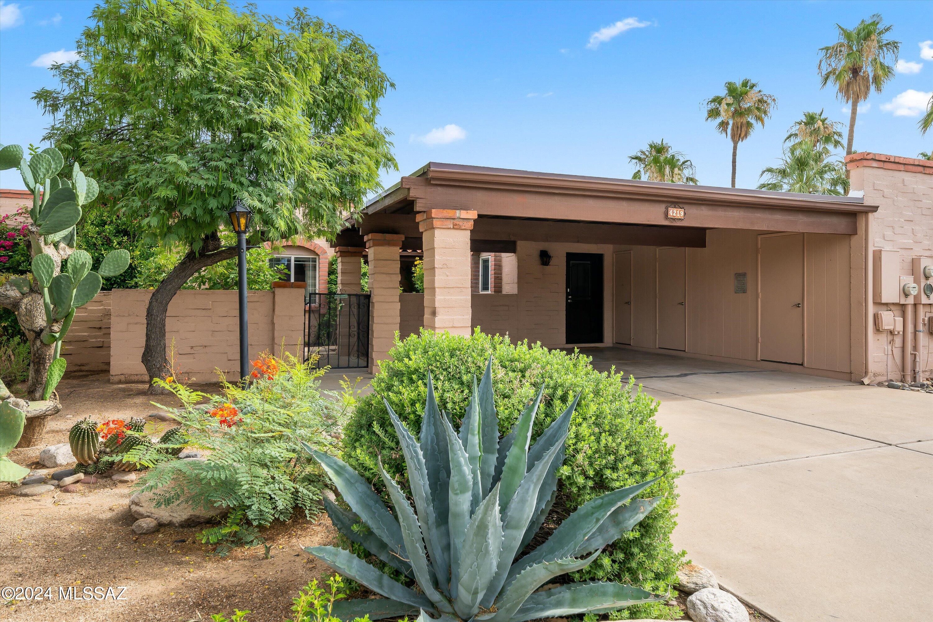 Welcome to this meticulously maintained and charming townhome in the heart of Tucson! Featuring a spacious, open floor plan, this delightful home offers two bedrooms, two full bathrooms, ceramic tile throughout, walk-in closets, and an abundance of natural light streaming through multiple skylights. A NEW ROOF was installed in October 2023, and the HVAC was replaced in 2018. Recently remodeled kitchen and bathrooms, including granite countertops and newer stainless steel appliances. Beautiful front patio and a 2-car carport with storage closets. Backyard includes mountain views and a covered patio, and has direct access to the community pool, spa, and clubhouse! Home is located close to guest parking for added convenience when entertaining. Centrally located, this townhome is in close proximity to endless amenities, the UofA, River Walk, Rillito River Park and The Loop Trail!