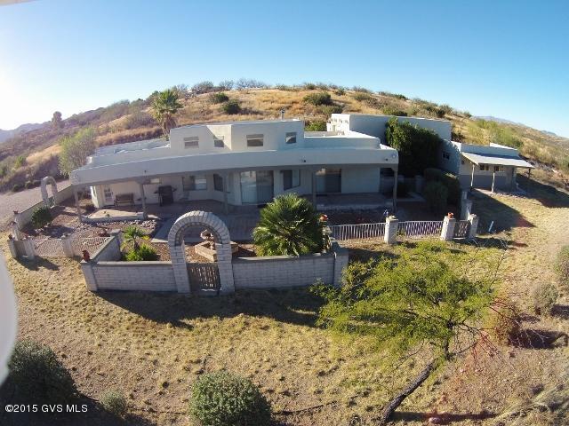 Incredible panoramic views! Home + studio/guest casita + RV garage! SW style home built to take advantage of views w/large windows, high ceiling, open floor plan + 14 X 23.5 ft full length covered patio facing views. Artists or guests will appreciate the Studio/guest casita w/ large covered porch. RV garage is approx. 22 X 32 ft w/10 ft door.Relax or entertain in enclosed yard with those Views! Few properties have both casita & RV garage. Freshly painted exterior & new carpet in bedrms.