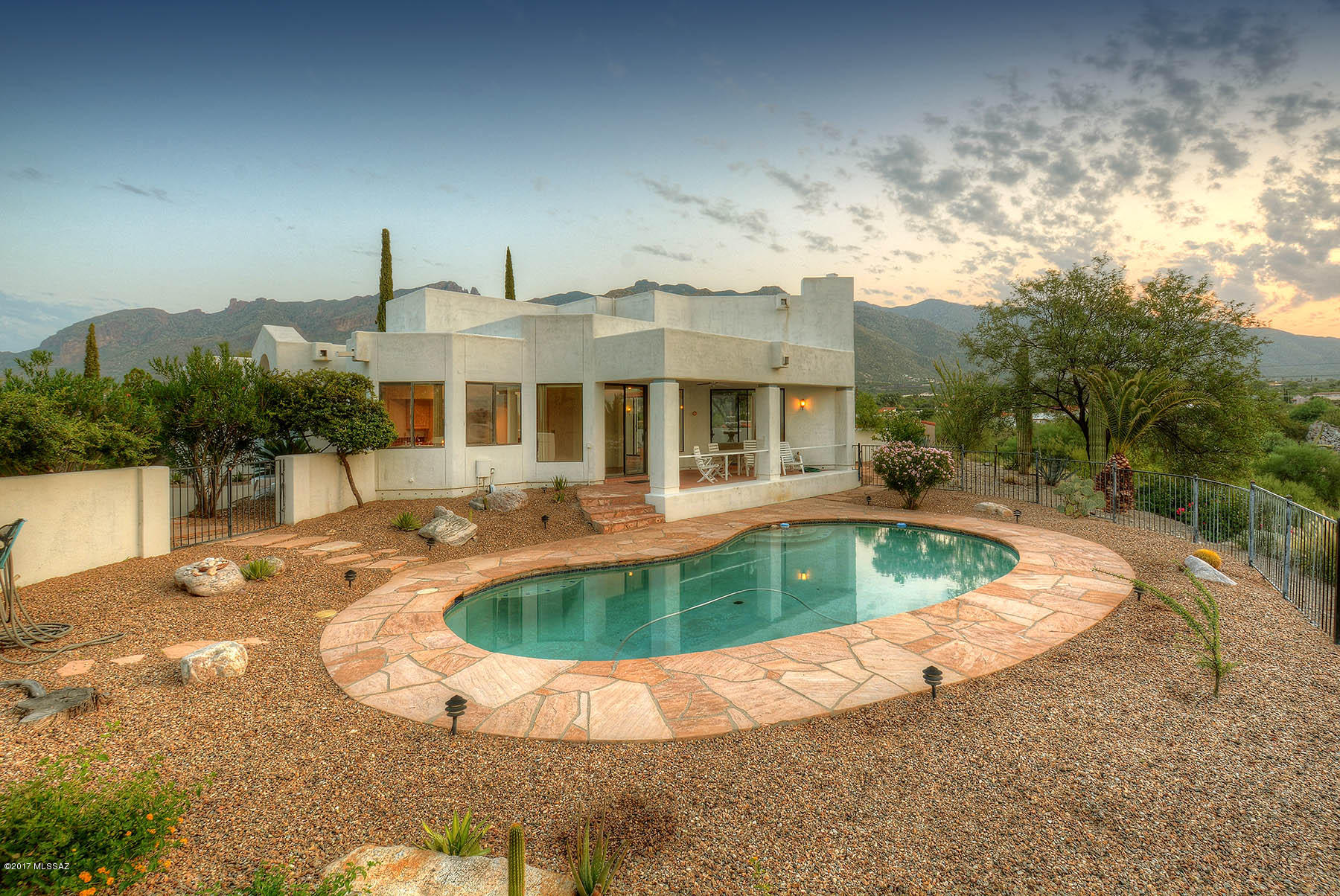 Set high in the Foothills, expansive windows bring in truly Panoramic Views!  A South facing Yard with Pool overlooks extraordinary City Views & Catalina Mountain Views embrace the charming bricked North Yard w/ a gracious Fountain. The Master opens to the North Yard with its Mtn Views; it features an oversized Jetted Tub and separate Shower; built for luxury, buyer may wish to enhance. 2nd BR has 'Murphy' Bed, built-ins & full-size Armoire all in rich Wood. The Spacious Layout with Island, Nook & Walk-in Pantry will be a fabulous Kitchen with updating. Freshly painted, New Carpet, lovely landscaping, natural Flagstone. Wet Bar off Great Rm for your most entertaining parties! Rare single family home on .65 Acres in Gated Kachina Hills. Warranties: AHS, Roof, Termite, 2017 Gas Water Heater