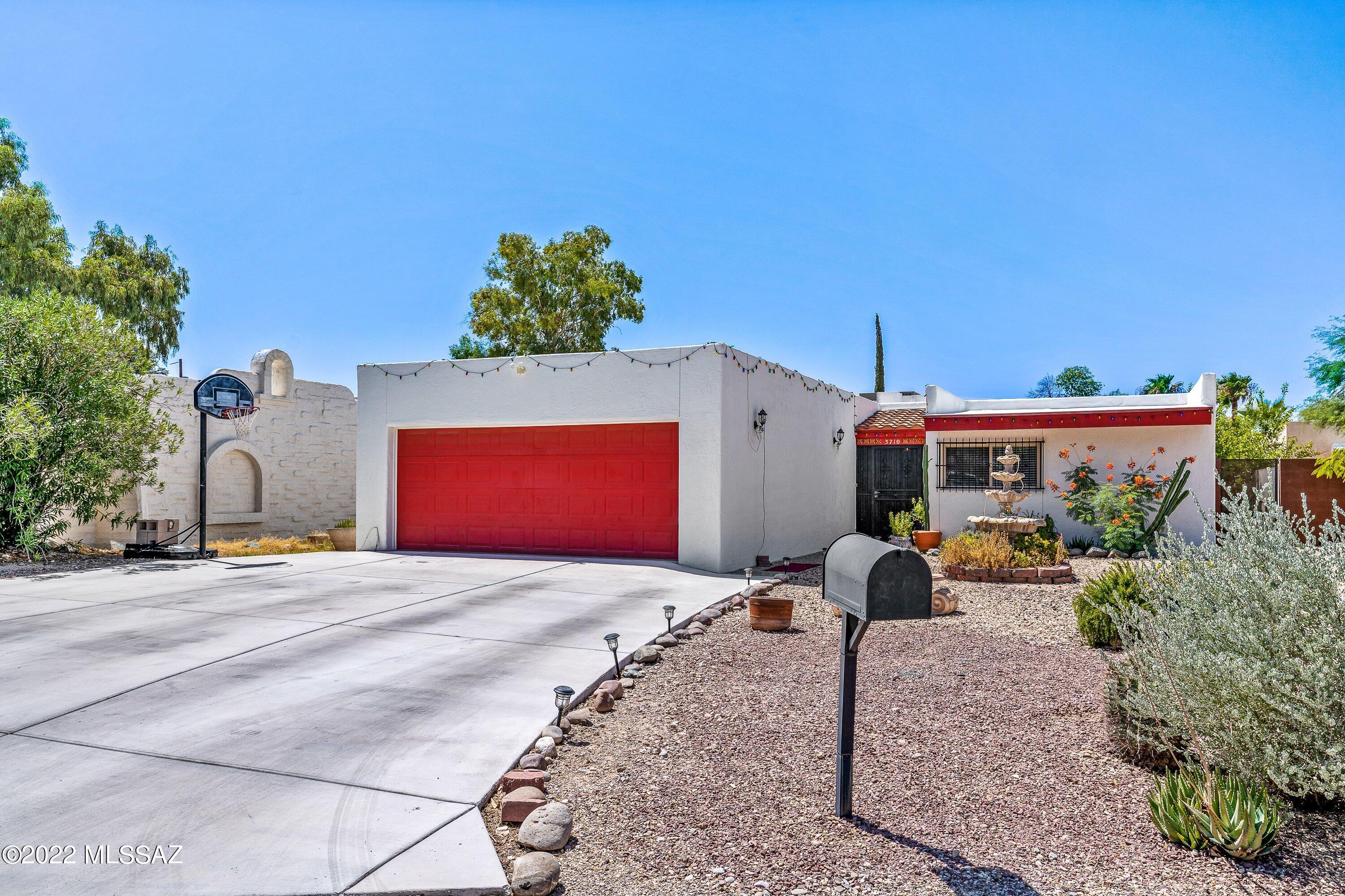Become a part of historic El Montevideo with this beautifully updated Spanish charmer! This 3 bedroom 2-bathroom home has it all! When walking in you are welcomed by an open foyer leading to the dining and living area. Relax in the step-down living room with a new colonial wood burning fireplace and exposed wood beam ceilings. The kitchen is inviting with the natural lighting coming from the skylight. The home has been updated with new: porcelain tile flooring throughout the kitchen, living room, and hallway, solid wood vanities in both bathrooms, and patterned tile. Step outside in the calming backyard and enjoy your summer nights by the outside fireplace making smores, or a cookout using the built in BBQ. - The exterior of the home features a gated entry way and wrought iron security bars. Close to Reid Park, Elcon Mall and downtown. Enjoy all the amenities mid-town has to offer!