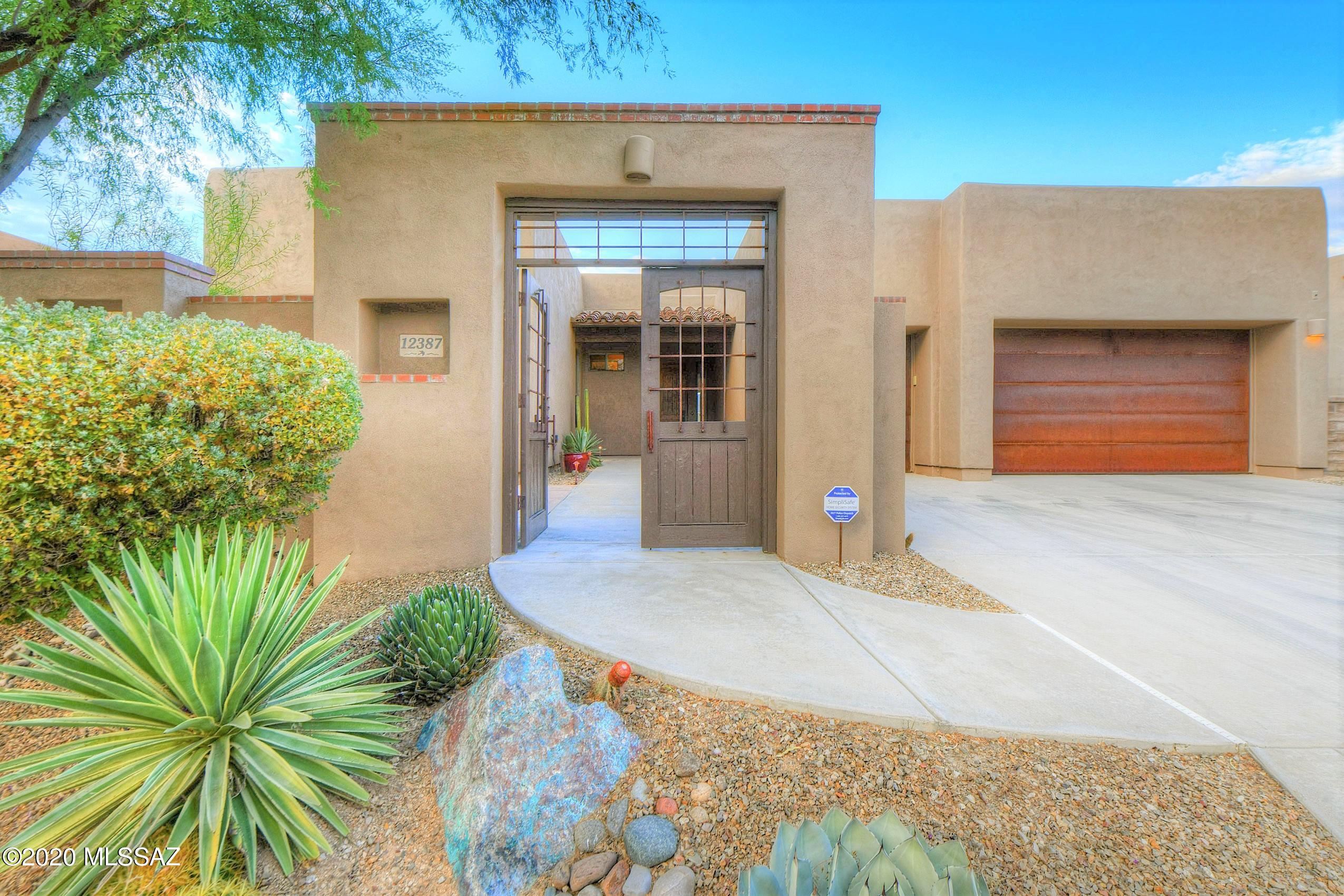 Gorgeous SW Contemporary Home in the Gated Community - Preserve at Dove Mountain. This Top Quality Insight Built 4BR/2BA Home w/ Soaring Ceilings, Luxurious Built-In's & Private Back Yard Oasis is Awaiting Your Arrival. Guests Enter through your Charming, Gated Front Courtyard. Welcome into Great Room w/ Magnificent Mountain Views! Your SW Elegant Kitchen w/ Center Island is the Heart of the Home - Open to Family Room w/ Cozy Beehive Fireplace & Entry to your PRIVATE Back Yard Oasis featuring Lovely Covered Patio, Extended Flagstone, Grill Island, Charming Gas Fireplace & Hot Tub w/ Breathtaking Sunset & Mountain Views backing to Natural Preserve. Stained Concrete Flooring throughout, Beautiful Master Suite w/ Jetted Tub & Walk-In Shower, Split Bedroom Floorplan & 3 Car Garage w/ Epoxy.