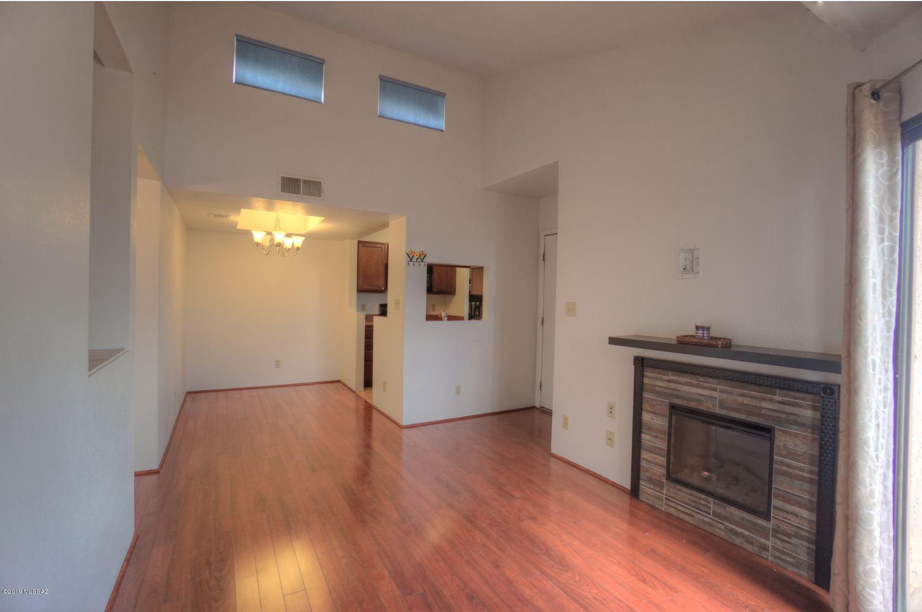 Located in the Gated Community Copper Star Condos, this cute 2nd floor condo has 2 bedrooms, 1 bath and is ''move in ready.'' Enter to a spacious living room with a fireplace, wood floors, a fully equipped kitchen with an adjacent dining room.  To add to the features of this home, is air conditioning, forced air heat, a balcony patio and additional storage. The Community amenities include: Controlled access, security cameras, pool, spa, basketball court, exercise room, clubhouse & laundry facility. Easy quick access to the Mountain Ave bike path, makes the condo only minutes to the U of A campus, University Medical Center and it's close to shopping dining and entertainment. and comes with an assigned parking space.