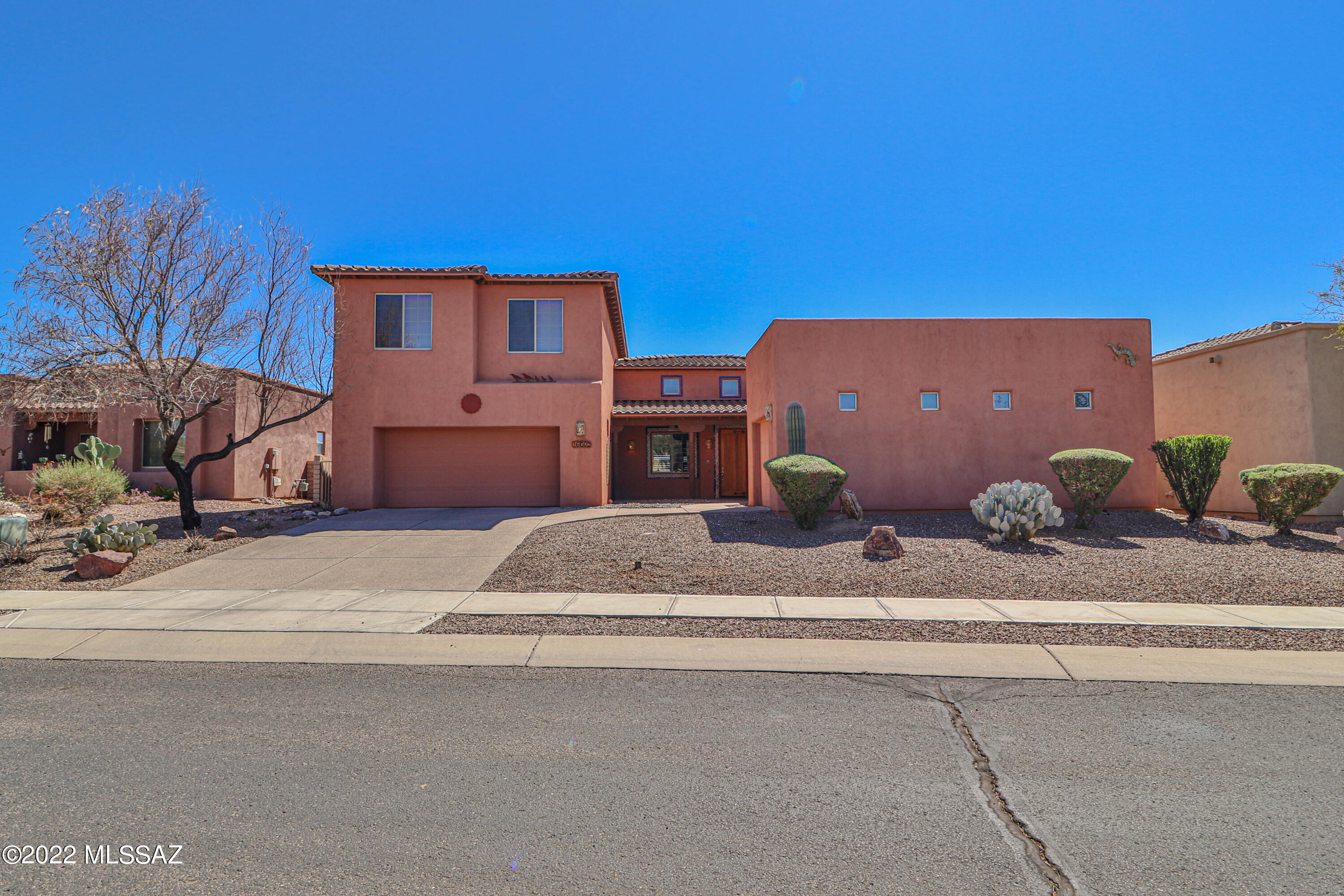 This is the one you have been waiting for!  Vail School District!  Gated Wingview subdivision in Rancho Del Lago!  This stunning custom 3005 SF home features 4 Beds, 3 Full Baths! Tile/laminate on entire first floor w/carpet upstairs! Vaulted Ceilings! Highly upgraded kitchen features dual stoves, gas cooktop, gorgeous custom cabinets/ granite counter tops!   2 living areas downstairs provides multiple entertainment areas for those family get togethers! Gas Fireplace! Large downstairs primary bedroom features custom southwest style bathroom/large walk-in closet!   Upstairs features 2 bedrooms w/full bath and loft that could be used as a game room/media room!  Premium lot overlooks award winning golf course! Extended length 3 car garage w/cabinets for storage.  And if that's not enough..... Step outside into your very own private backyard oasis that features a huge covered patio with carved wood posts, pebbletech pool with water feature, turf and flagstone to enjoy those million dollar mountain and sunset views!  Schedule your showing today!
