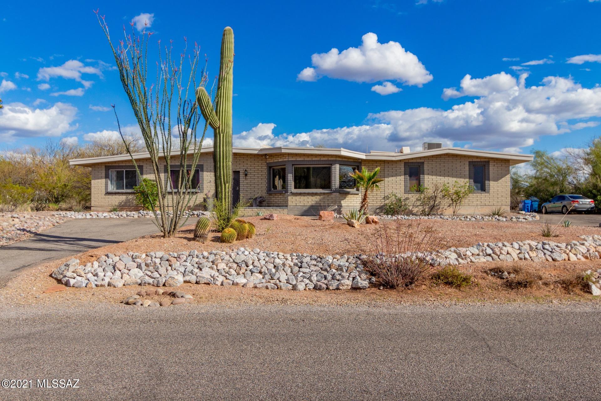 Sensational Home on an acre w/breathtaking Mountain & desert views! Soaring ceilings, handsome painted concrete floors throughout, skylights, wood burning fireplace, built-in window-seat, & vast views from every window. Stunning chef's kitchen features a center island, breakfast bar, butcher block counters, upgraded lighting, recessed lighting, pantry, SS appliances, & plethora of white cabinetry w/hardware.  Bonus room w/endless possibilities, generous size bedrooms, ample closets, & an interior laundry room. Master retreat boasts patio access, exquisite mural, & private en suite. Enjoy the sparkling pool, extended covered patio, walking trails, basketball court, & magnificent views.