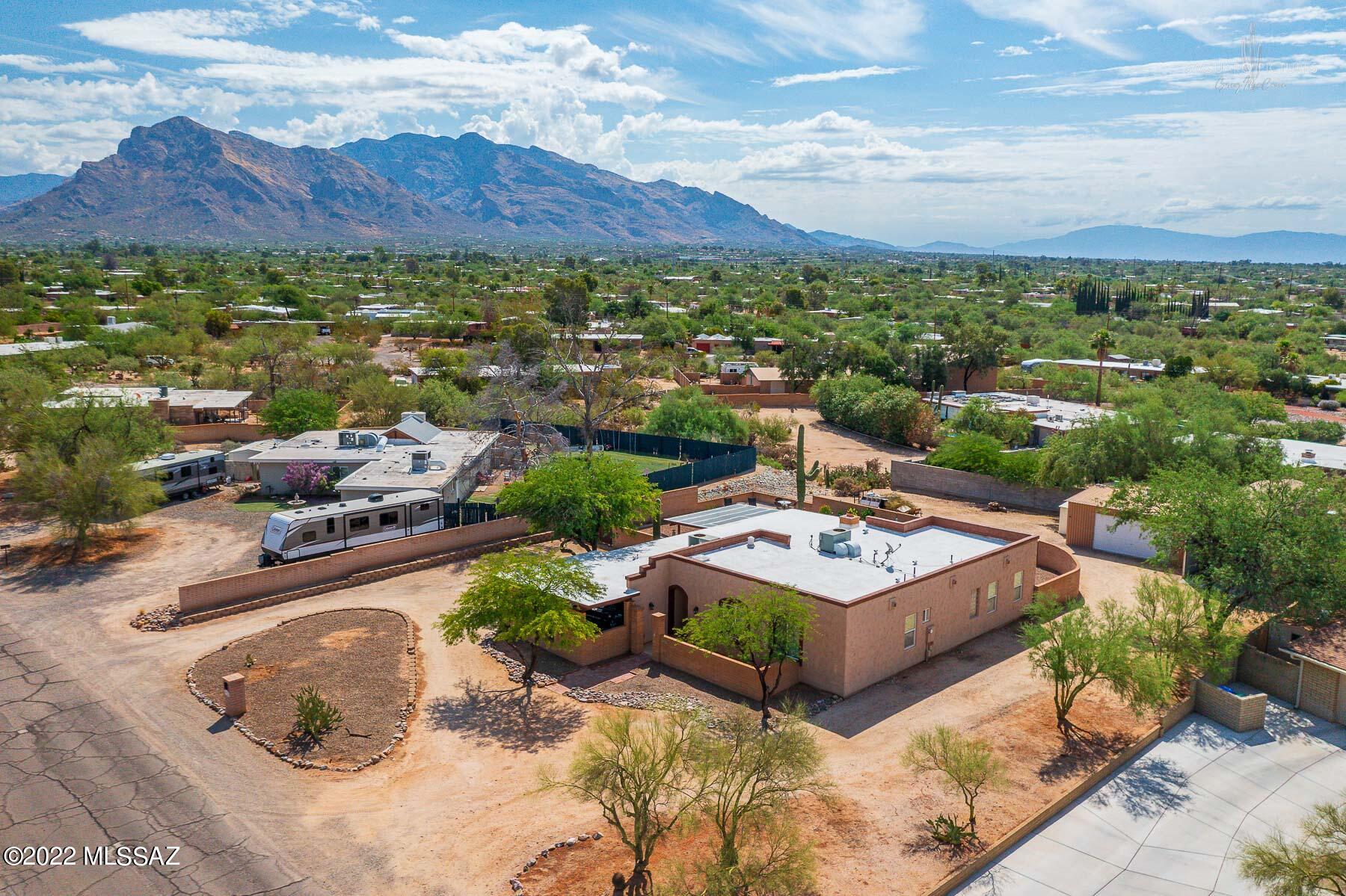 This exceptional home is a lucky find! A home that encompasses so many needs & wants for buyers.  The highlights of this remarkable home are plentiful.  The bedrooms are all extra-large with 9ft+ tall ceilings.  The guest bath is unique with luxurious Corian top dual vanity, shower & extra deep soaking tub.  The master bedroom is very sizeable with walk in closet, door to patio & a lavish master bath.  The master bath features spacious Corian top dual vanity, large garden tub & sizable walk-in shower.  The kitchen presents stainless steel appliances, breakfast bar & attractive granite countertops.  Walk out back into paradise with a lush backyard containing a generous covered porch looking out on to the refreshing pool with splendid mountain views!  Yet there is more! Along with the 2 car carport is a detached heated & cooled oversized garage with work space featuring 110 & 220 power.  There is also a desirable covered RV parking spot with concrete foundation.  Property features full RV hookups that includes 50 amp power.  Don't miss out Book your appointment today to see this remarkable home!