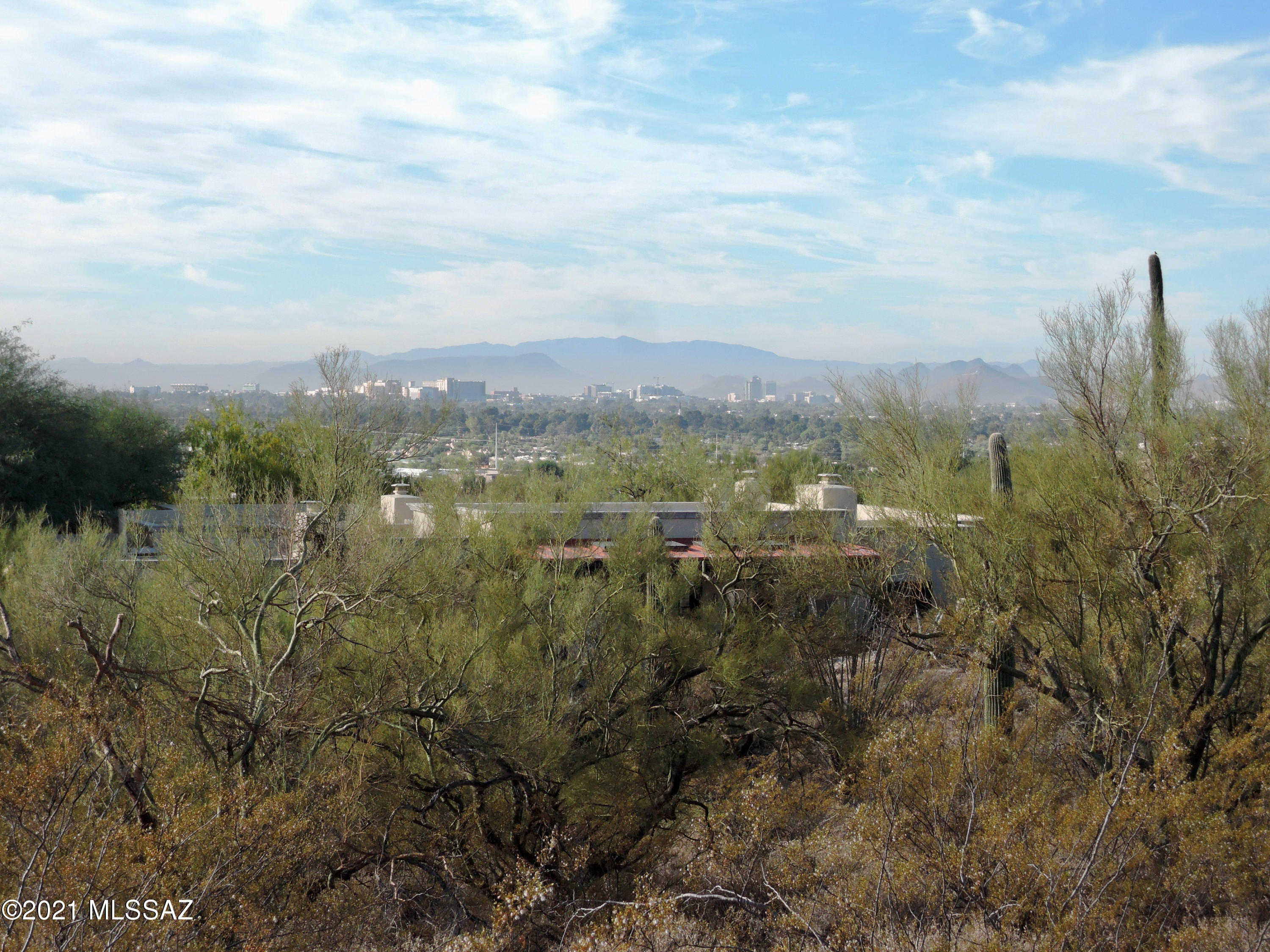 Rare 2.1 acre ridge-top lot with city, mountain, sunrise and sunset views in guard gated Cat10 in the heart of the Catalina Foothills.  Great spacing and privacy due to the larger-than-normal average lot size.  The generous lot size and easy building site,  together with the views, privacy and spacing make this home site extremely rare.