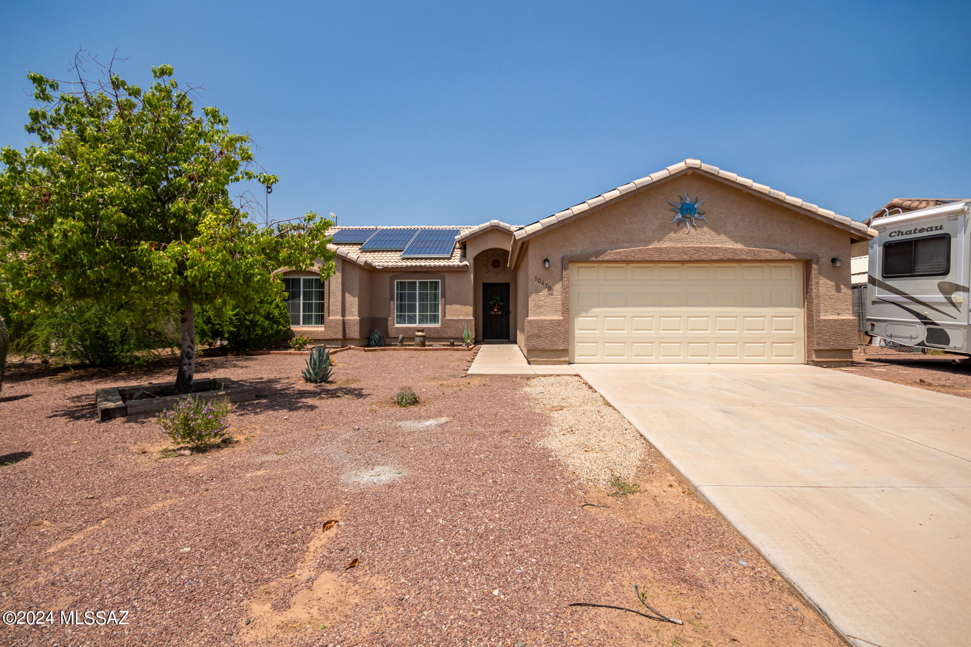 Discover the joy of owning this charming single-level residence! This delightful home features a large 2 car garage. It also has an RV gate with plenty of room to park your RV. With easy-care desert landscape. Step inside to find a desirable great room. The modern kitchen boasts recessed lighting, stainless steel appliances, granite counter tops. With many more upgrades. Nothing better than your own private inground pool and BBQ area. This home will not last long.