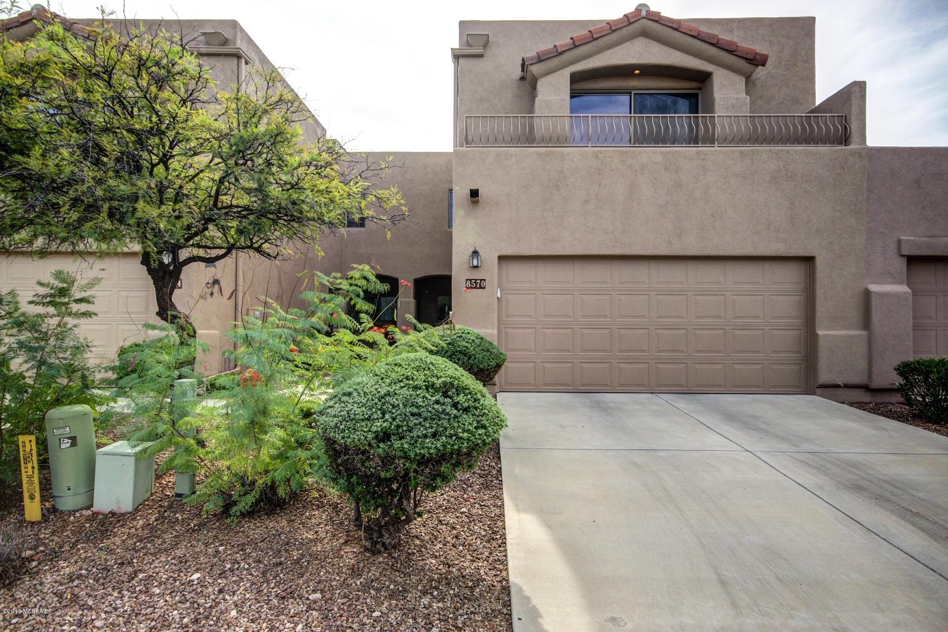 PLAZA BONITA SAYS IT ALL!  Come see this beautiful, quaint & gated community with lush vegetation & mountain views!  This particular unit has 3 bed/2 bath upstairs with den + 3/4 bathroom downstairs! Soaring ceilings, fans, recessed lighting, & lots of natural lighting compliment the unique architectural lines!  Very functional kitchen features gas stove, newer stainless refrigerator, pull out cabinets & breakfast bar.  Garage door opener just replaced along with newly painted exterior!  Water softener, washer & dryer included!  Massive master bedroom has sitting area & balcony overlooking Catalina Mountains! Master bathroom has separate shower & garden tub with large walk-in closet.  Cozy backyard is very private & easy care landscaping.  Convenient to everything. Won't last long!