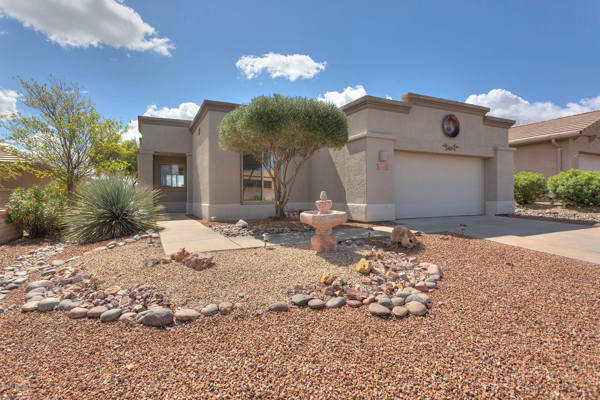 Are you looking for a great opportunity to put your personal touches on a home in a great neighborhood? This is it! The contemporary floor plan featuring an open concept great room, delivers a kitchen bar serving island, ample counter tops, oak wood cabinetry and bright white appliances. The kitchen flows perfectly into a dining area with backyard views. The great room has two giant picture windows that drench the room in natural radiant light. Your expansive master bedroom suite has a quiet sitting area with a fun garden bay window and a French door providing access to the patio. The master bath offers double sinks and natural light from two high transom windows. Relax on the covered patio with its flowing flagstone extension designed for relaxing in the shade of a mature Mesquite  tree and enjoying the backdrop Mountain views. This is your chance to use your imagination and TLC to make this into the perfect winter home!