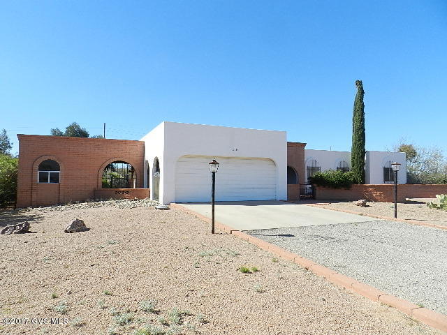 Large 3 bedroom house on huge lot! Mountain views from large backyard that is completely enclosed with brick wall. New interior paint and flooring! Easy care desert landscaping in front yard, brick courtyard leads to front entry. Master bedroom has own door to yard & walk-in closet. Master bath has makeup vanity. Corner fireplace in living room. Rear yard already done with gravel, red brick pavers & covered patio. Attached storage as well as 2 car garage. With some updating this home could be gorgeous!