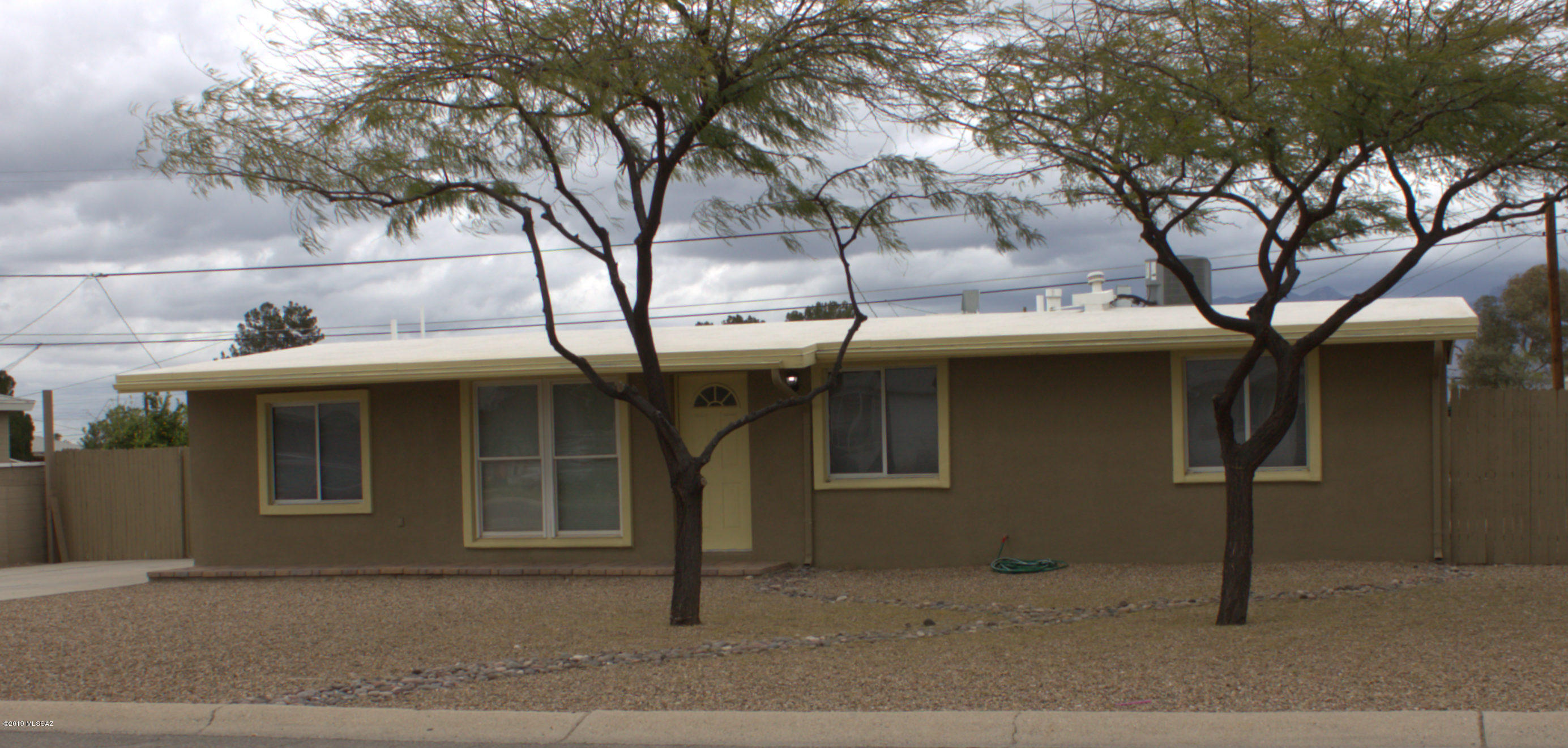 Great Started Home! Enjoy this single home on a Beautiful developed Large Lot.  With extensive backyard patio & raised patio with Catalina mountain views! Pride of ownership comes this home. Recently painted exterior, 3 year old HVAC system, updated window & doors.  Three Bedrooms and two baths - split floor plan.  Vaulted ceilings, updated kitchen with stainless steel appliances, tile & carpet - updated baths.  This home sits on a lot that leaves room for RV parking (w/double gate), newer wood fence, decorative gravel front and back, double car driveway, & mature front yard trees. This home is in move in condition! This home is in the Pathway to Purchase zip code that allows for up to $17,000 down payment assistance.  Call for additional information concerning this program.