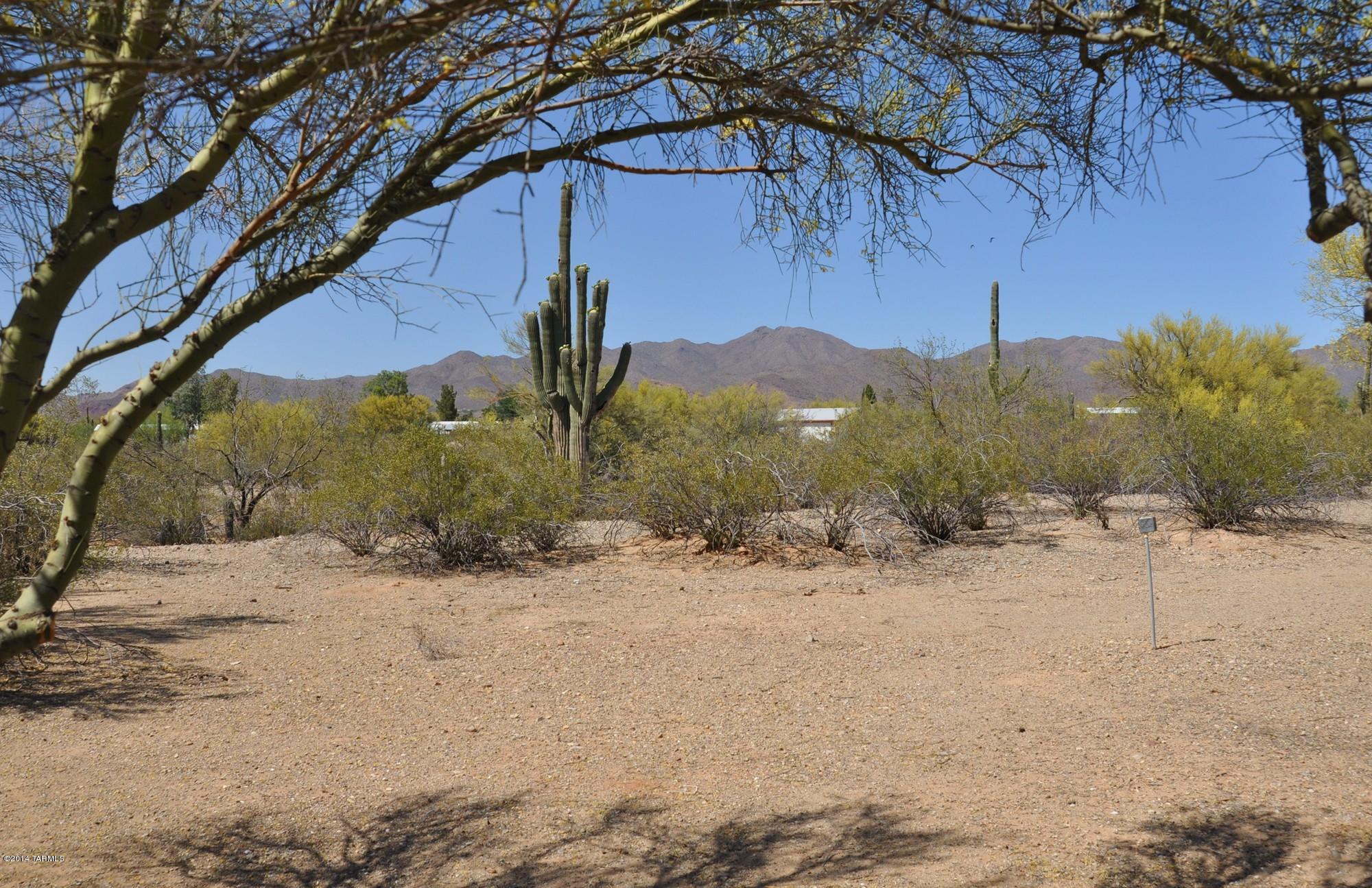 Wow! Mountain Views! Saguaros! Flat Land, Pretty Palo Verde trees! Fully Fenced Acre with solar powered, automatic gate. Detached work shop! The residence is a 24 x 40 Schulte. Say ''Hello'' to country life! Great for full time or winter residence. Covered front deck. Covered patio in rear w/EZ access ramp. Living room features a bay window! Full sized dining area. Split bedroom plan. Flexible SH zoning allows possibility for 2nd residence. Horses OK! Pride of ownership rural neighborhood. You'll love it! Carport Tall enough for an RV! City Water! SW Gas! Direct TV. Recent Central AC!
