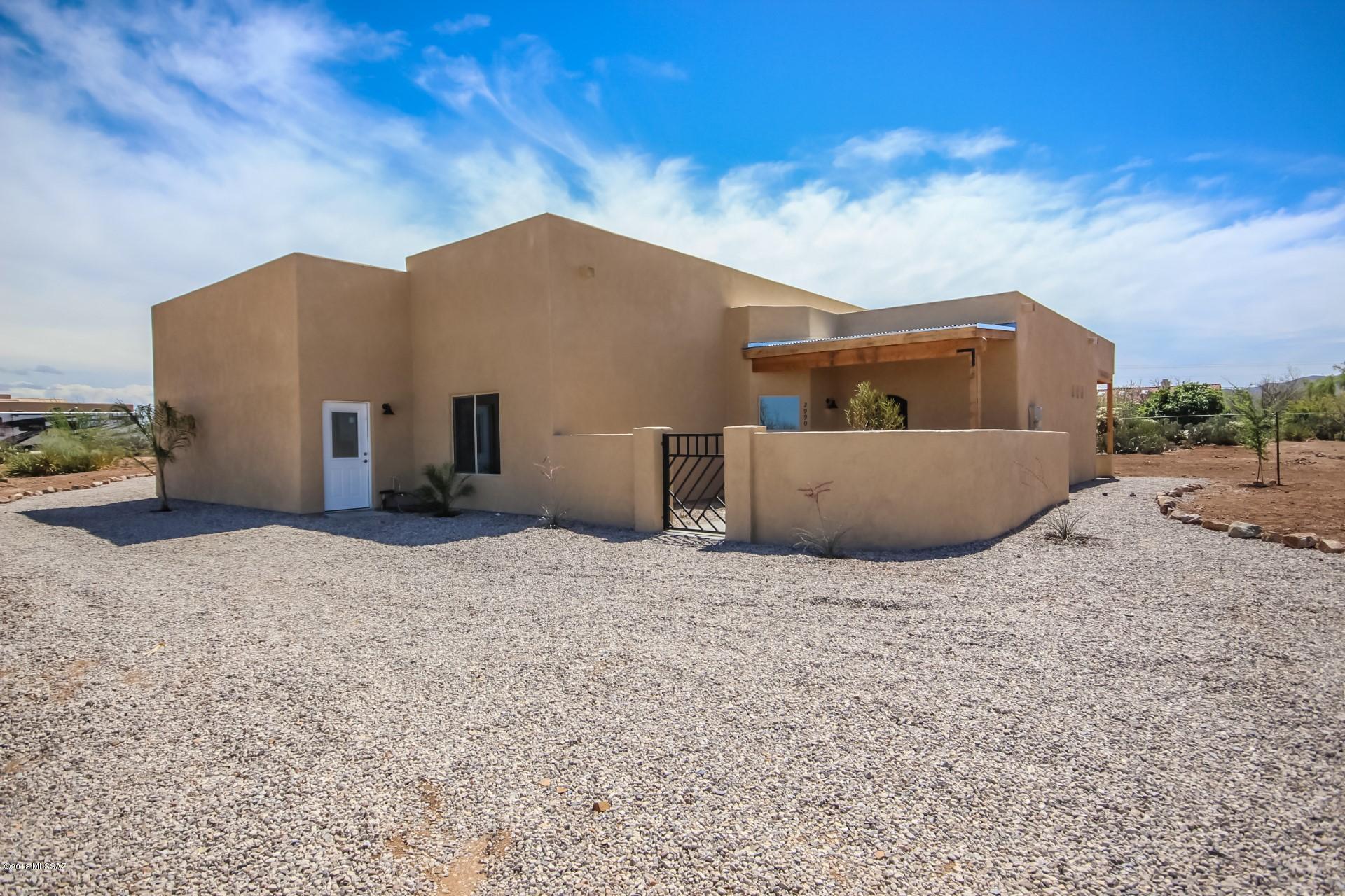 Outstanding custom build nestled on over an acre of land with breathtaking Mountain Views & 10' ceilings throughout! 135' back yard wall being built - Call for details! Beautifully stained concrete floors throughout,stunning chef's kitchen with granite counters, glass tiled backslash and SS appliances, skylights throughout the home for natural lighting. French door to patio from breakfast nook. Perfect Home for entertaining. Grand master retreat boasts French doors to patio, walk-in closets, and private en suite. Generous size bedrooms, ample closets, and 2.5 baths with granite. Large laundry room with utility sink and storage cabinets. Covered backyard patio and plenty of room for your future desert oasis.