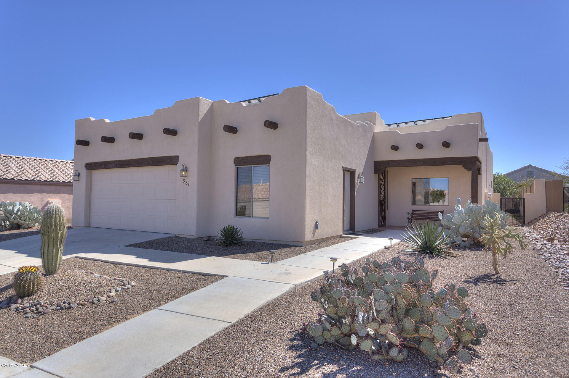 3BD/2BA semi-custom Santa Fe style home by Figueroa in Desert Creek with Santa Rita views. The upgrades & enhancements are too many to list, but let's start with solar (electric & water heating), new tile floors (same throughout home), near ceiling to floor windows (more views), granite countertops, upgraded stainless steel appliances with gas oven/stove, custom cabinets, gas fireplace in Great Room and Master BD, laundry room with front load pedestal washer & dryer and plumbed for extra sink, custom security doors & an extended 2&1/2 car garage with added window & side entrance (golf cart or workshop anyone?). There is much more to list but this home is immaculate and move-in ready today! Some furnishings available by SBOS. Must see!!