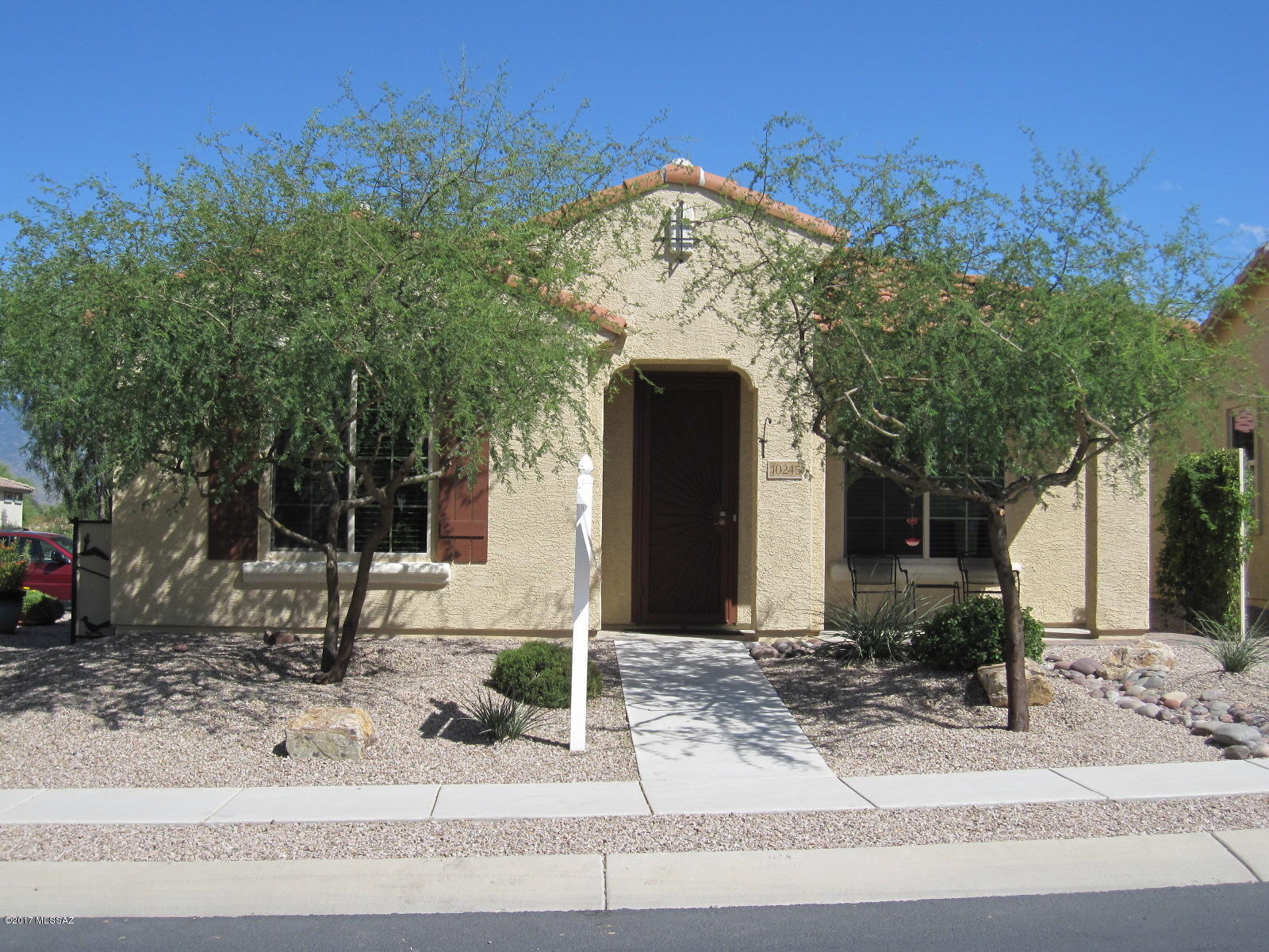 New listing in Del Webb at Rancho del Lago, a gated active adult 55+ community in scenic Vail. Clean and move-in ready! Corner lot adjacent to guest parking. 1609 sf Promenade plan, 2 Bedrooms + Den. Deluxe kitchen features stainless appliances, granite, low island, and decorator Kona maple cabinets. 20'' tile in living areas, berber carpet in bdrms.  Relaxing north courtyard with pergola, privacy wall, gutters & pavers. Solar electric (seller owned). Water softener, reverse osmosis, tankless hot water heater, solar tubes. Epoxy floor,  and cabinets in Garage. Mature landscaping. Custom wall, gate, screen & security door. See addl upgrades list under Documents tab! Golf, tennis, 2 pools, spa, fitness center, walking path.Community lodge hosts recreation center activities. Why wait to build