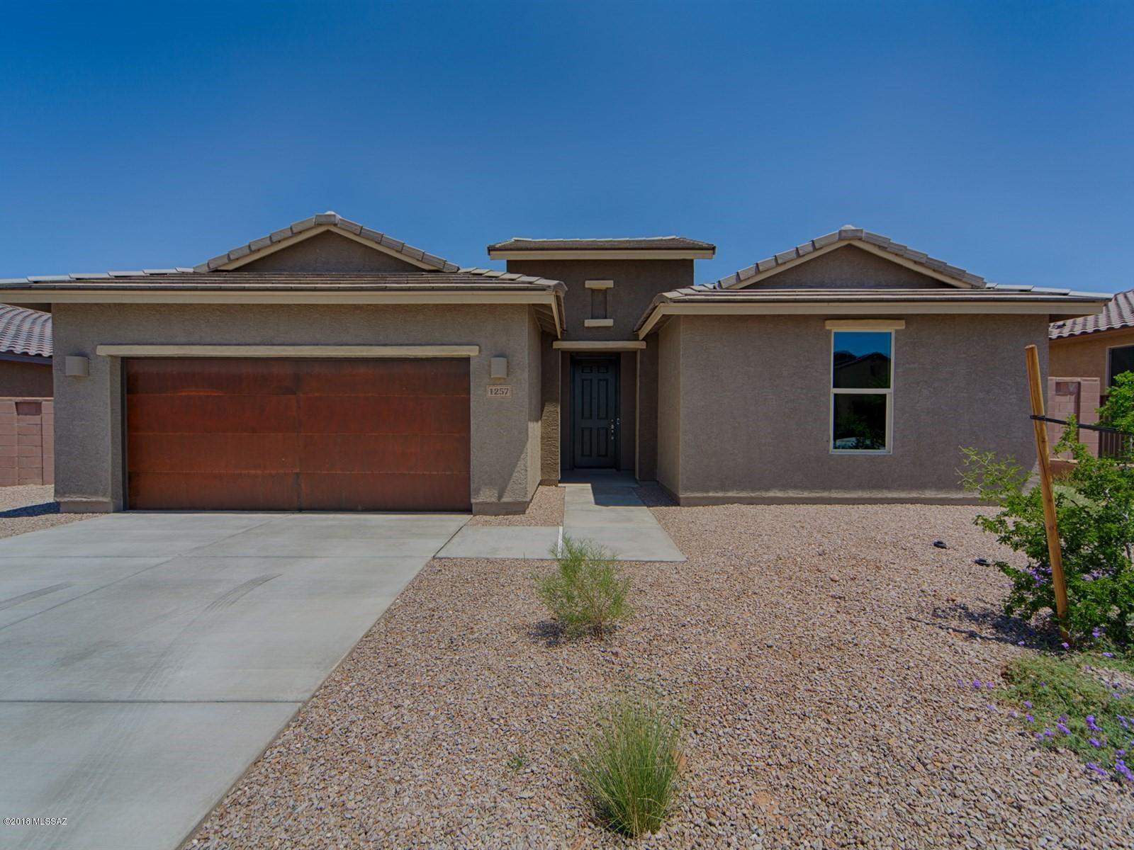 Brand NEW energy-efficient home ready NOW! The beautiful Tosto features 42'' upper Espresso kitchen cabinets with new sunset gold granite countertops. Cabinets in the tech center and laundry room for extra storage. Rustic overlay garage doors with 2' garage extension. Glazed porcelian tile that looks like wood flooring. Love living at Madera with the sport courts, swimming pool, parks and playground. Known for their energy-efficient features, our homes help you live a healthier and quieter lifestyle while saving thousands on energy bills.