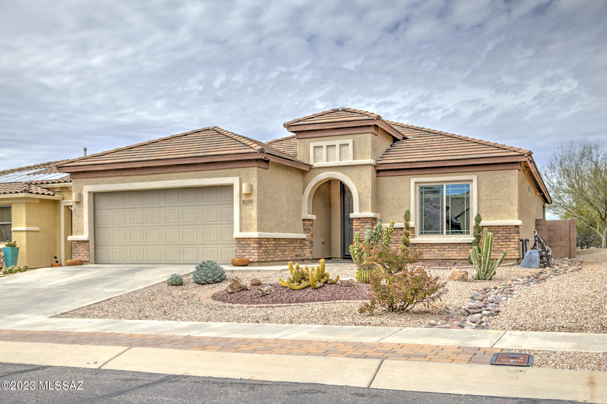 Resort living in this beautifully maintained 55+ community.  This home is in a Prime location near the pool, Lodge, Tennis & Pickleball Courts, it's a corner lot with natural desert common area to the East and North. 3BR/2BA plus Den. Premium Granite Kitchen Island seats 6 comfortably, custom tiled backsplash. Bay window in primary bedroom and primary bath has large shower w/bench, 2 Master closets, and double sink vanity. Large laundry room w/utility sink. Lots of storage with a pantry in kitchen and an extra-large Interior storage closet, whole house has water filtration system. Walled backyard has covered patio w/ fountain, great for relaxing and entertaining! 4' extended garage with keyless entry. Owner Agent The wall mounted TV and Surround sound in the living room as well as the electric lawn mower will remain with no warranty.  The mounted cabinets in the garage will remain. The bar stools and some other furniture are negotiable in a separate Bill of Sale.