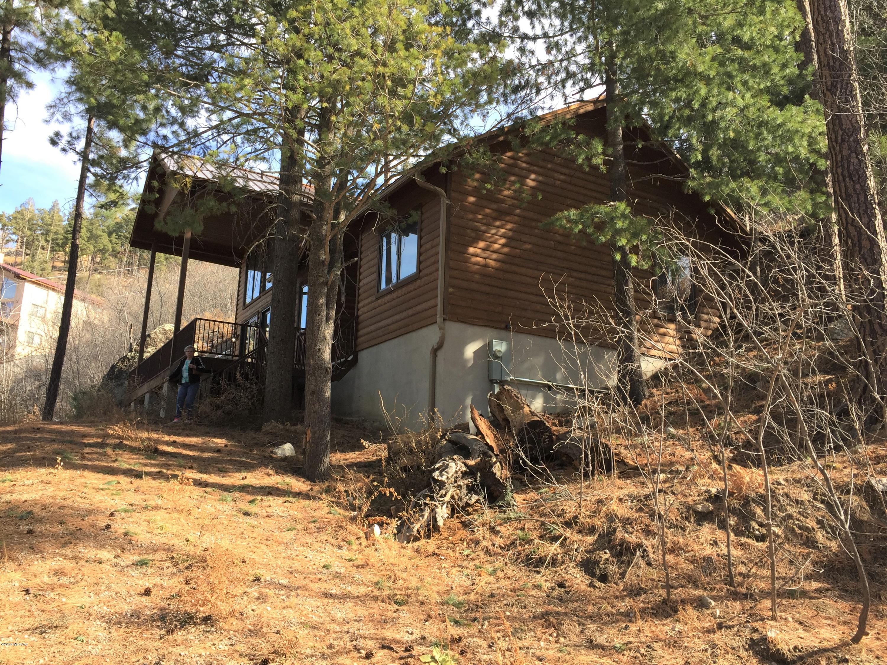 Looking for a place to get away and enjoy the quiet & serenity of this cabin situated amidst the pines.  This is it! Great room has a 2-story wood burning fireplace. Kitchen has all the conveniences you could want- pull-out drawers in cabinets & actual drawers to keep it organized. Nice sized pantry too. One bedroom & bath downstairs and another bedroom & bath up as well as the loft that is open to the lower level.  Doors & baseboards are Knotty Pine,  both baths have tile surrounds & a closet holds the stacked washer & dryer.  High efficient Pella windows & exterior doors. House sits on two lots. Enjoy the wildlife & the whisper of the wind thru the trees.  This beauty is just waiting for you.  CONCRETE DRIVEWAY AND PARKING PAD INSTALLED.