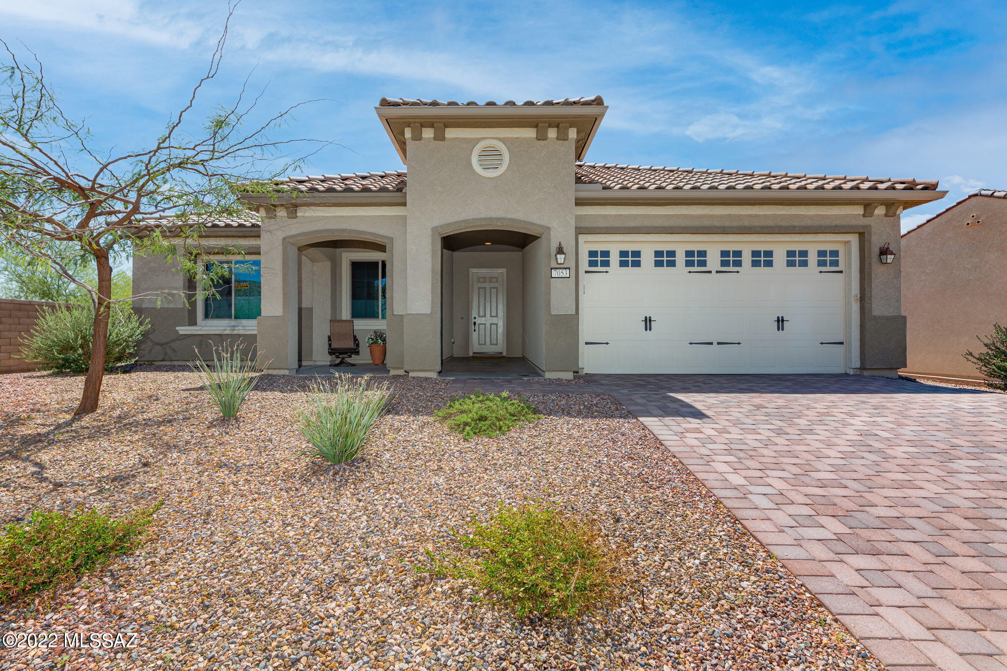 This Stunning 2,103 SqFt, 2 BD + Den, 2.5 BA home with Solar is located in Del Webb at Dove Mountain and sits on a corner lot with Open Space Behind, Mountain Views, and City Lights at night. The wide walkway leads you from the paved driveway to a spacious covered patio where you can relax or visit with neighbors while enjoying the spectacular views that surround you. Once inside you will be delighted by how bright and beautiful the Pursuit ﬂoor plan is, boasting 10' ceilings, 8' interior doors, Hickory Hardwood Flooring, and Alder Cabinets throughout. This open split bedroom ﬂoor plan is made to please, as it features a sizable Great Room with an AV built-in with niches and glass shelves, and a window wall with slider that maximizes the sunlight and picturesque views. The Gourmet Kitchen is perfectly appointed with a large island with bar seating, gorgeous granite countertops, staggered soft close Alder cabinetry with under-cabinet lights, gas cooktop, and so much more. The large Dining Area offers plenty of space to entertain guests, and features a bow window that lets in natural light. The Owner's Suite is sure to satisfy, as it offers plenty of privacy and is appointed with a coffered ceiling, bow window, executive height vanity with double sink, walk-in shower with seat, and a large walk-in closet. The Secondary Bedroom adjoins the spacious Den / Office with french doors, Powder Room with pedestal sink, and a Hall Bath featuring a walk-in shower with seat and raised height vanity. If you are in need of more space, the extended 2 Car Garage offers a Bonus Room  that can be utilized for additional Storage or a Work / Hobby Space, as it offers AC and a ceiling fan. Whether you are relaxing or entertaining guests, you will thoroughly enjoy the fabulous outdoor living space, offering a large Covered Patio with Built-in Gas Fireplace and an Extended Paver Patio that is perfect for soaking up some sun or stargazing at night. Enjoy Tucson Living at its finest with the many amenities that Del Webb has to offer, while surrounded by Gorgeous Tortolita Mountain Views, Beautiful Hiking and Biking Trails, and well known Golf Courses.