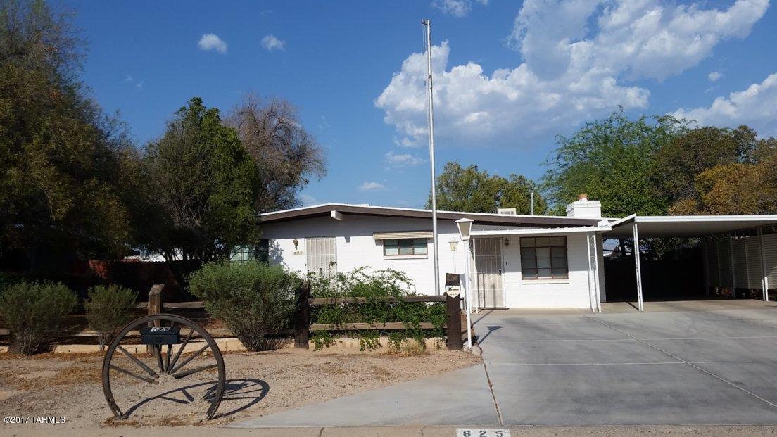 Centrally located, well loved and maintained home. Lot size encourages relaxing in the backyard and cement driveway provides ample parking. Ceiling fans in all 4 bedrooms. Dual evaporative coolers, one unit new 2016. Reclaimed brick fireplace from historic Tucson. Stay cool in the attached workshop. Well lit street. Lots of possibilities with this property. No HOA. Agent related to seller.