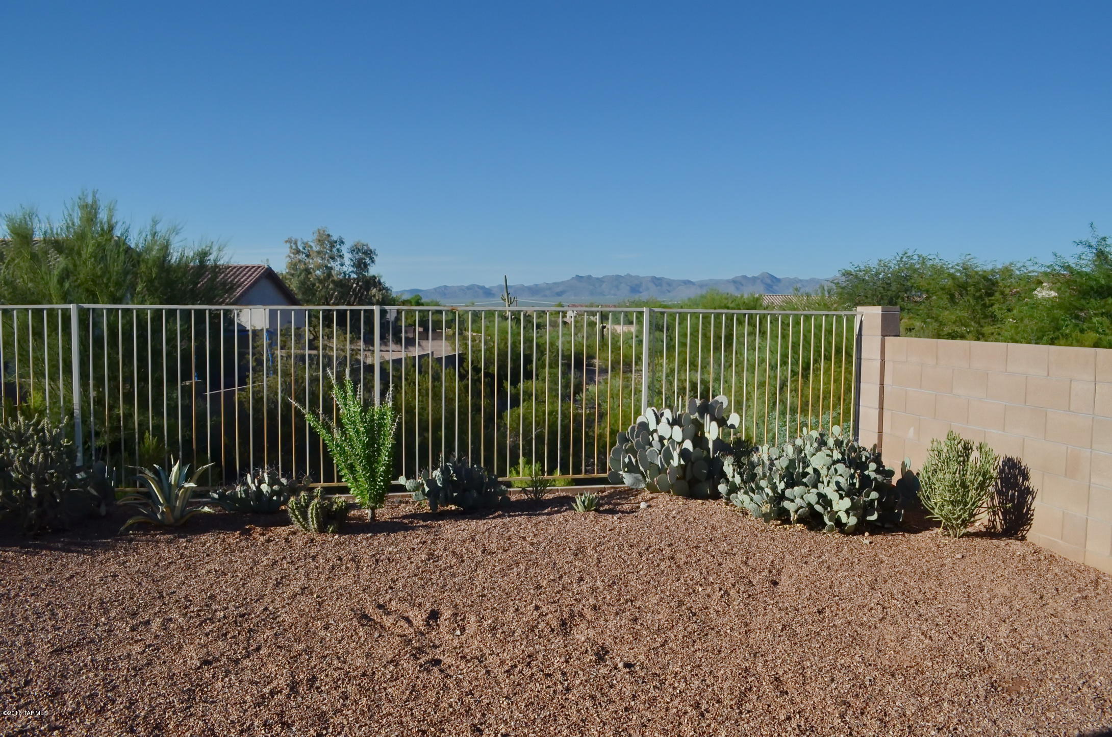 Beautiful views await you! Home has open concept/easy flow floor plan for everyday living. Wood laminate floors and ceramic tile throughout, ceiling fans in every room. New 40 gal water heater in 2015. 3BR/2BA w/low flow toilets. Master bedroom has french doors with retractable screen door leading to large covered patio that backs to a green belt for privacy and has N orientation for great shade. Vaulted ceilings and bay window in living room for additional space. Extended garage for extra storage. This home has it all for easy living.