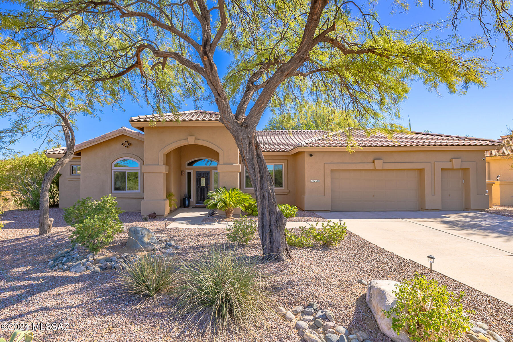 Gorgeous 4BD/3BA +Den (2,518 sq ft) home on .58 acre lot boasts a tranquil, resort-style yard with palm trees, heated pool/spa, outdoor kitchen & Kiva fireplace. Updates galore include new HVAC (2019), roof (2018) plus windows/carpet/water heater/water softener/irrigation system. Impressive foyer flanks dining room w/ tray ceiling. Beyond lies a Den plus open concept Great room with art/media wall. Gourmet kitchen hosts breakfast bar & nook, center island, dual SS ovens/microwave/magnetic induction cooktop & walk-in pantry. Split bedroom plan showcases Owner's suite hosting luxury bath w/ soaking tub, walk-in shower, custom closet. Granite counters throughout. Extended golf cart garage with new A/C & floor plus tons of storage. Large, fenced garden and citrus trees. A true desert retreat!