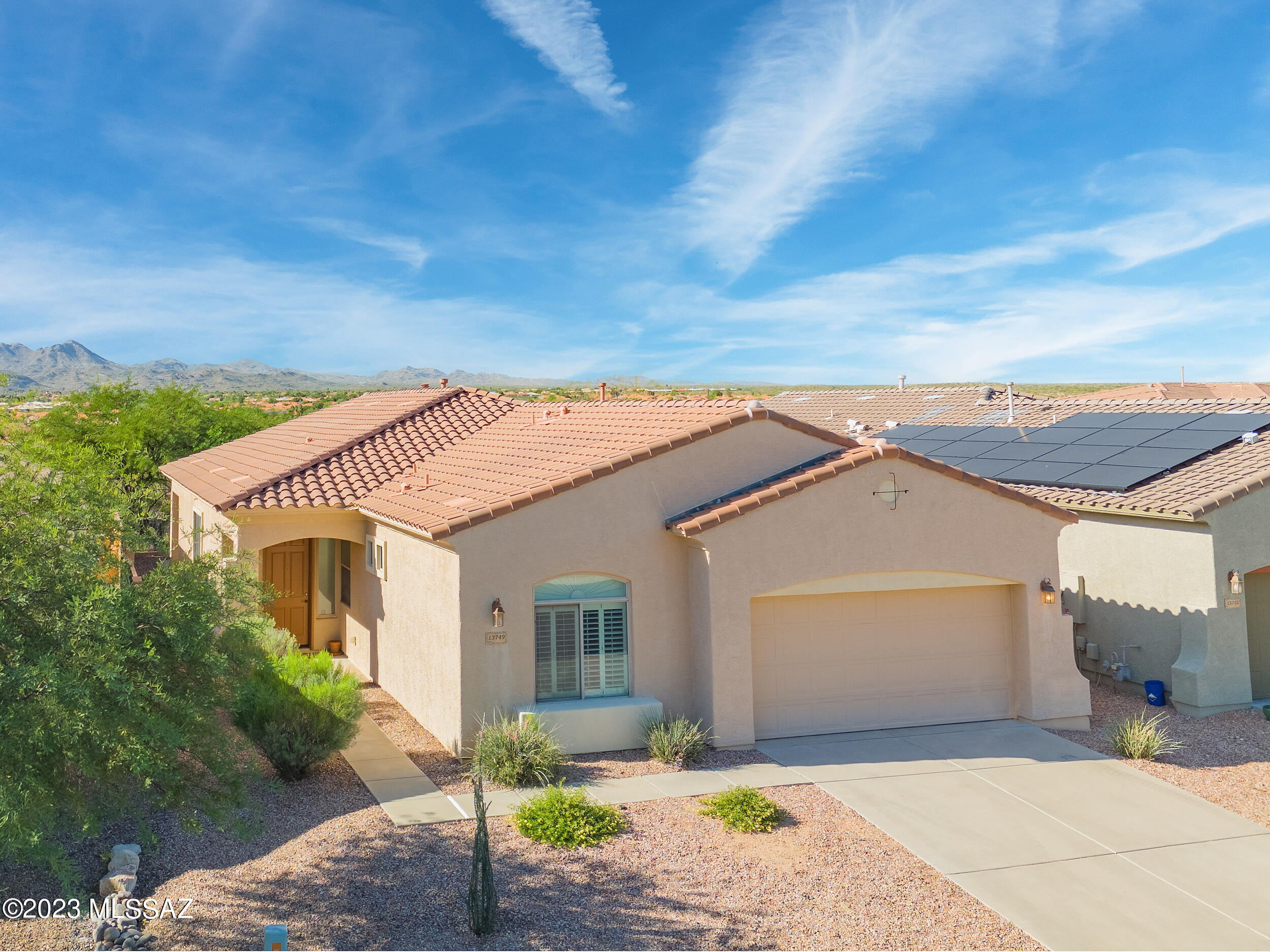 In this small enclave of Rancho Vistoso, come enjoy the serenity of Oro Valley. This bright, open four bedroom, two bathroom home offers privacy and convenience to amenities. Large great room with kitchen island and fireplace. Primary bedroom has spacious en-suite bathroom with private toilet, separate tub, and walk in closet. Split floorplan, large laundry, and the oversized garage has tandem for 3rd vehicle space or hobbies. New carpet in bedrooms, covered porch, paver patio, and green space beyond yard to enjoy sunsets and entertain. Come make this your retreat in the beautiful Sonoran desert.