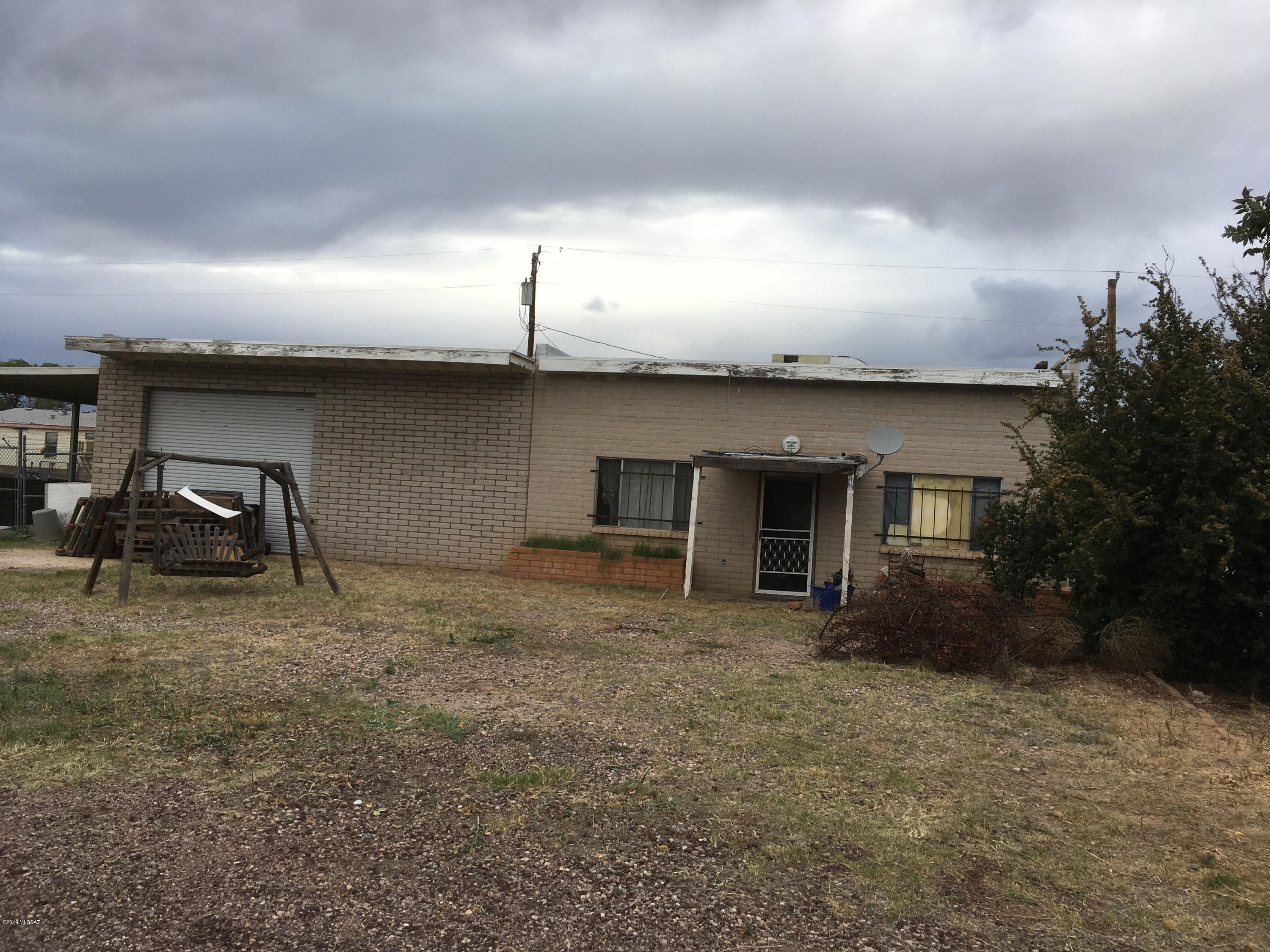 One story block Warehouse/Industrial - two full size garage openings plus office space and bath with shower.  Has been used for auto and storage - large building and large lot - many uses. Multiple use area - mostly residential/mobiles/site built but, other similar commercial in area also a couple trailer parks.