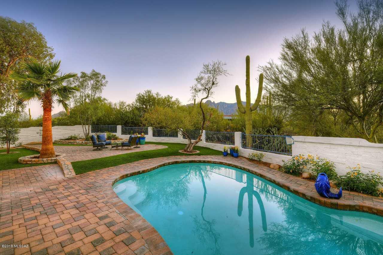 Quite honestly, a home like none other. That rare blend of gracious, charming, and one of the most livable floor plans I have seen. Think 2 inviting living spaces shared by a 2 way fireplace yet has that rare ''real'' family room that is perfect for every gathering, large or small.  Think an amazing kitchen that is open and casual.  The master suite is simply soothing with soft colors and wonderful bathroom. The other 3 bedrooms are all large with custom wood shutters and I especially like that one bedroom and bath is tucked on the other side of the house so is perfect for office or guests.  The outside spaces epitomize Tucson living. You know. Outside dining that is perfect for a first cup of coffee or a dinner. Inviting  pool, patios, and all you can hear are the birds. I love it.