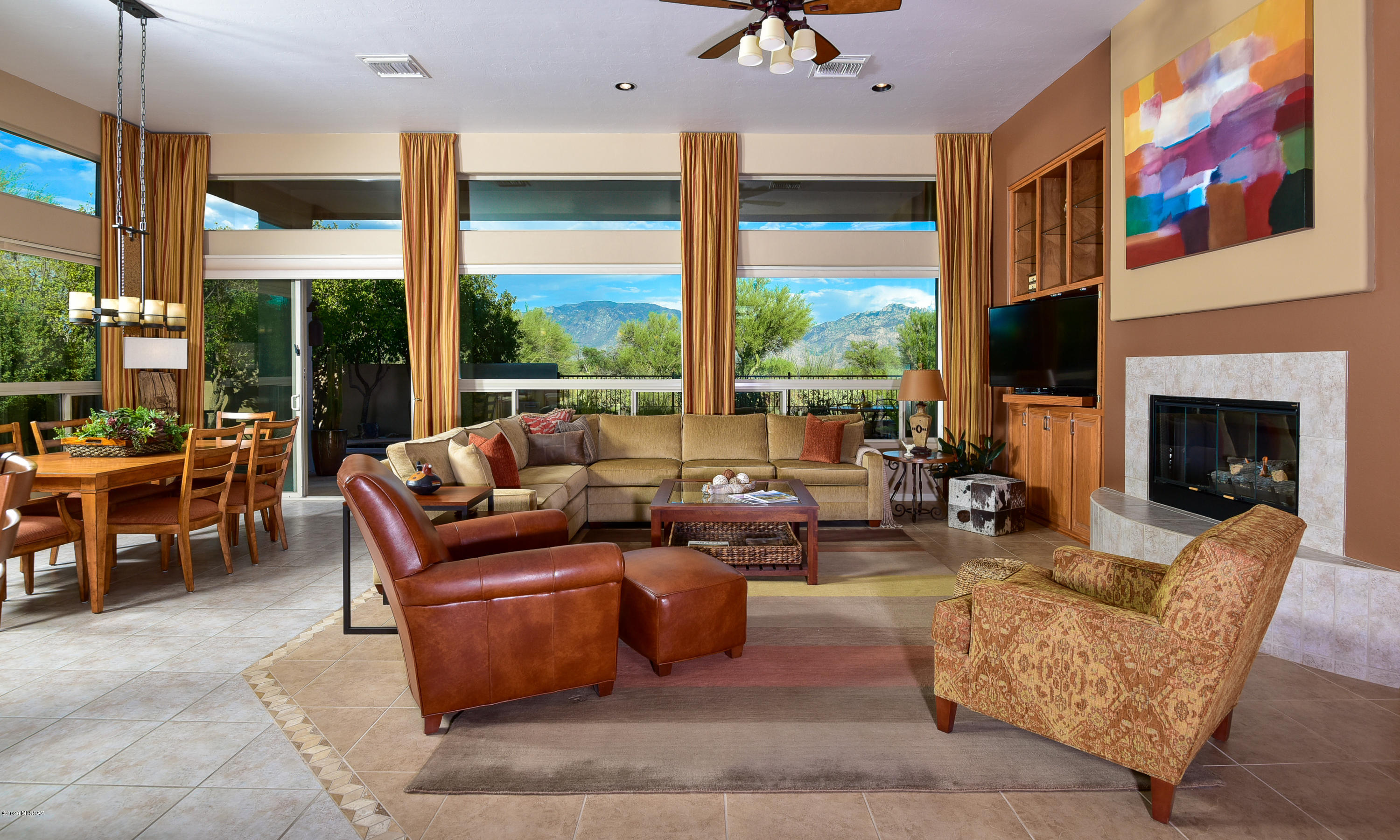Gorgeous luxury 2,549sf 2BD, 3BA & Den villa with Catalina Mtn views!  Gated 68-home community with heated pool, spa & BBQ area.  Front courtyard for morning coffee or sunset enjoyment.  Spacious kitchen (SS appls: gas cooktop, refrigerator, 2 ovens, M/W, D/W, wine ref), granite ctrs, prep island & huge bar counter.  All tile floors throughout!  Great room with high ceilings & windows frame desert & mountain views. Fireplace flanked by custom media & art shelves. Stunning master suite with custom closet & bath plus private Guest Suite, powder rm & Den. Soothing spa & fountain for patio relaxation. Owned solar, finished garage floors, automatic rolling sunscreens & shutters.  Located in Oro Valley the Scottsdale of Tucson & next to Phil Mickelson's Stone Canyon championship golf course.