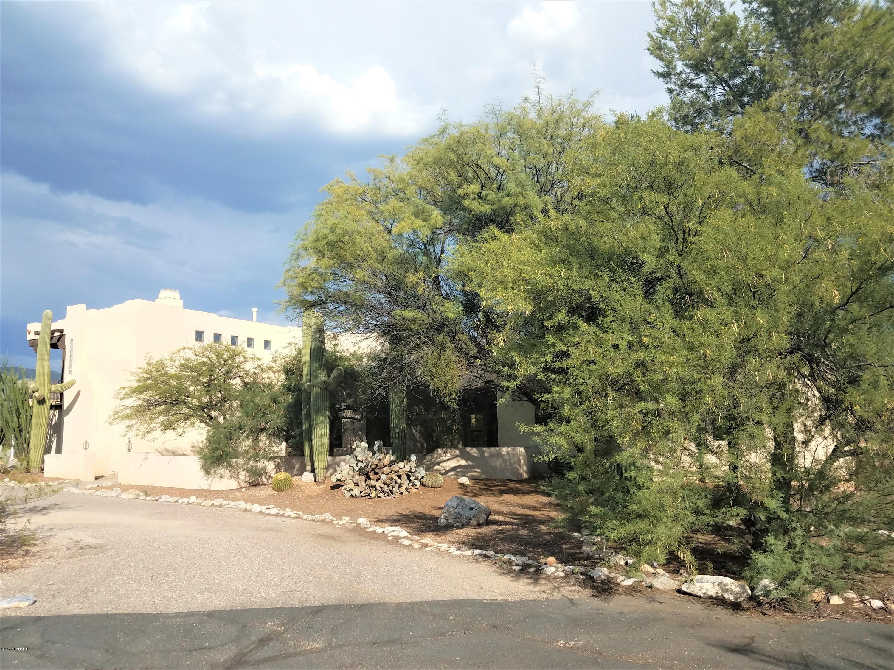 Incredible find in the very desirable northeast Tanque Verde area.  This beautiful large family home features a formal living room, dinning room, family room with fireplace, large gourmet kitchen with nook. Three bedrooms downstairs, one with it's own bathroom, guest bathroom and half bathroom leading to pool area.  Upstairs is the large master suite, and master bathroom that share a fireplace.  Enjoy mountain views from two different bedroom balconies on different sides of the house.  This home also has a large conventional swimming pool and spa.  There is a large building that serves as horse stables.  Enjoy incredible mountain views from your back patio, great for relaxing or entertaining. Don't let this jem, slip through you fingers.