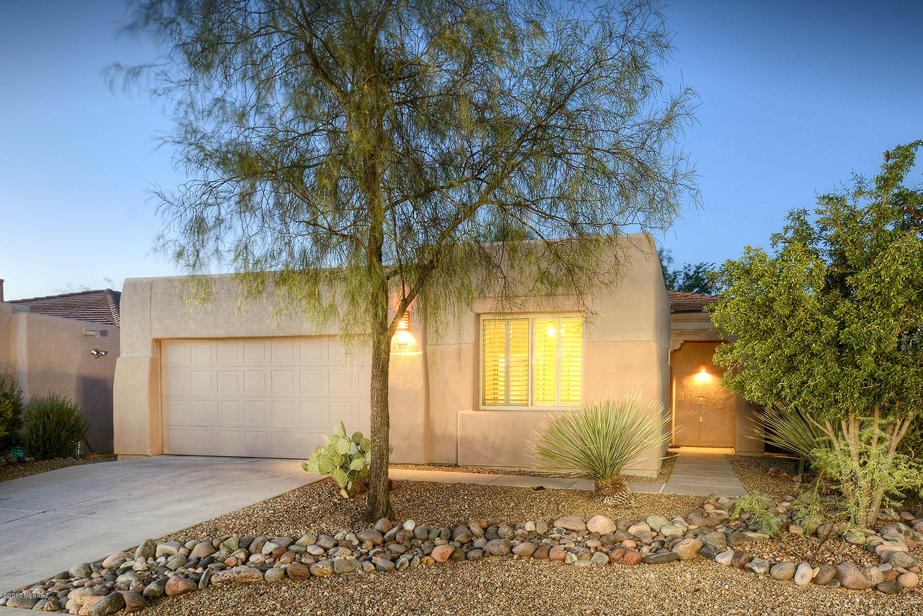 Pride of ownership is evident in this move-in ready and meticulously cared for home in Sweetwater in the Foothills, a gated community nestled in the serene Tucson Mountains. Features include tile throughout home, no carpet, wood shutters on nearly every window, and ceiling fans in every room. Interior two-tone paint, updated kitchen and baths, and professional landscaping make this home special! All appliances included. Desirable North/South exposure. Community amenities include pool, shaded playground, picnic ramada and beautifully landscaped common areas. This sparkling home is ready for its new owners! Only 15 minutes from downtown and 20 minutes from University of Arizona. See floor plan and photo captions.