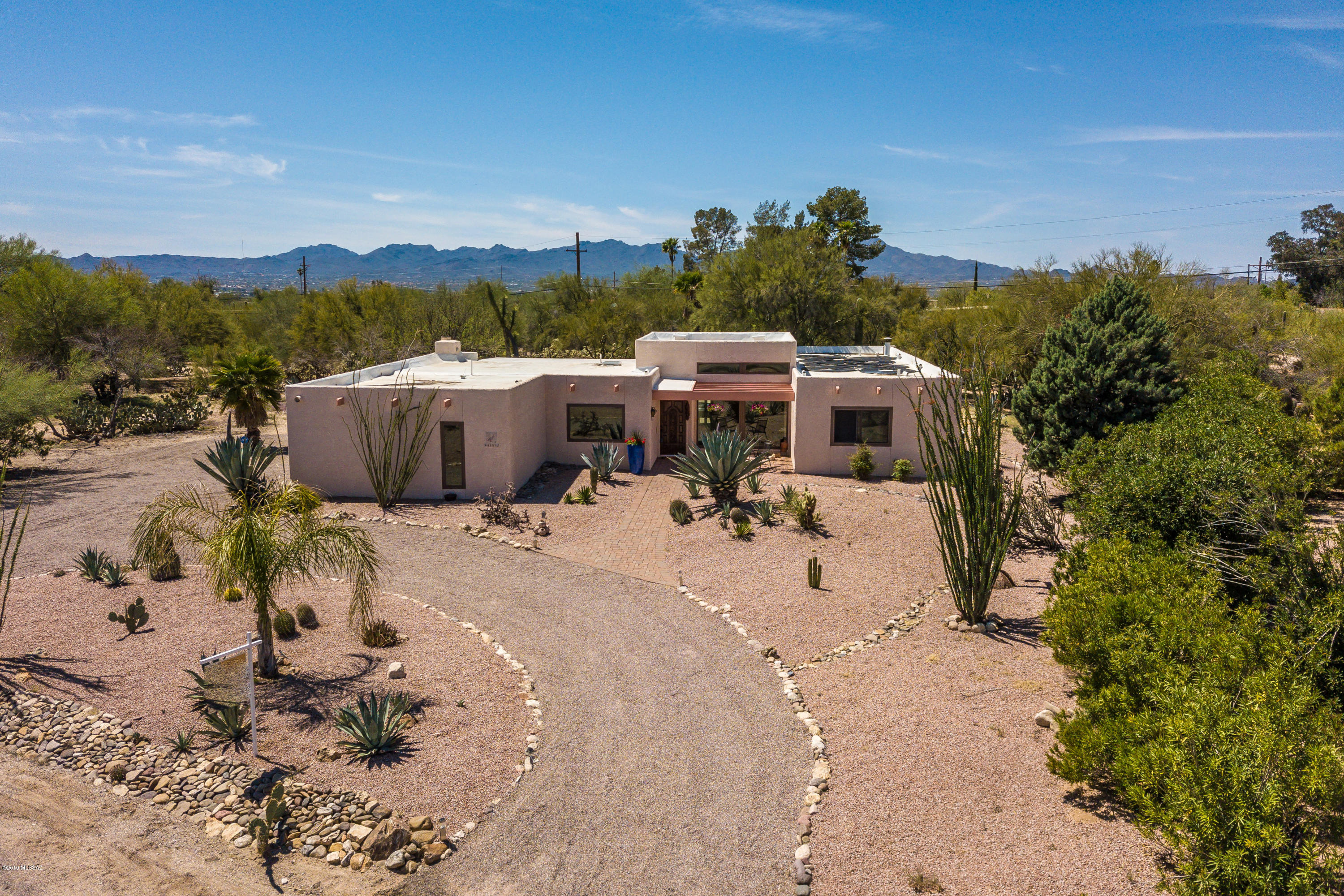 Charming 1979 Contemporary in Sahara Palms on large corner lot surrounded by desert! Bright, open living space with Great Room / Family Room and Kitchen area for gatherings. Enjoy the ambiance of the beehive fireplace in the Great Room area. This flowing style encompasses the large dining area plus a separate Formal Living Room / Studio area with views of the Catalinas. Relax by the sparkling pool in your large private backyard under your full covered patio! And enjoy starry nights in your own hot tub. Plus swim year round! Pool is heated with new technology heat pump – efficient enough to use on those cold winter days when the solar heating doesn't quite hack it! Newer dual and triple pane windows for maximum efficiency! An immaculate home, and a gem! Come and see now, it'll sell quickl
