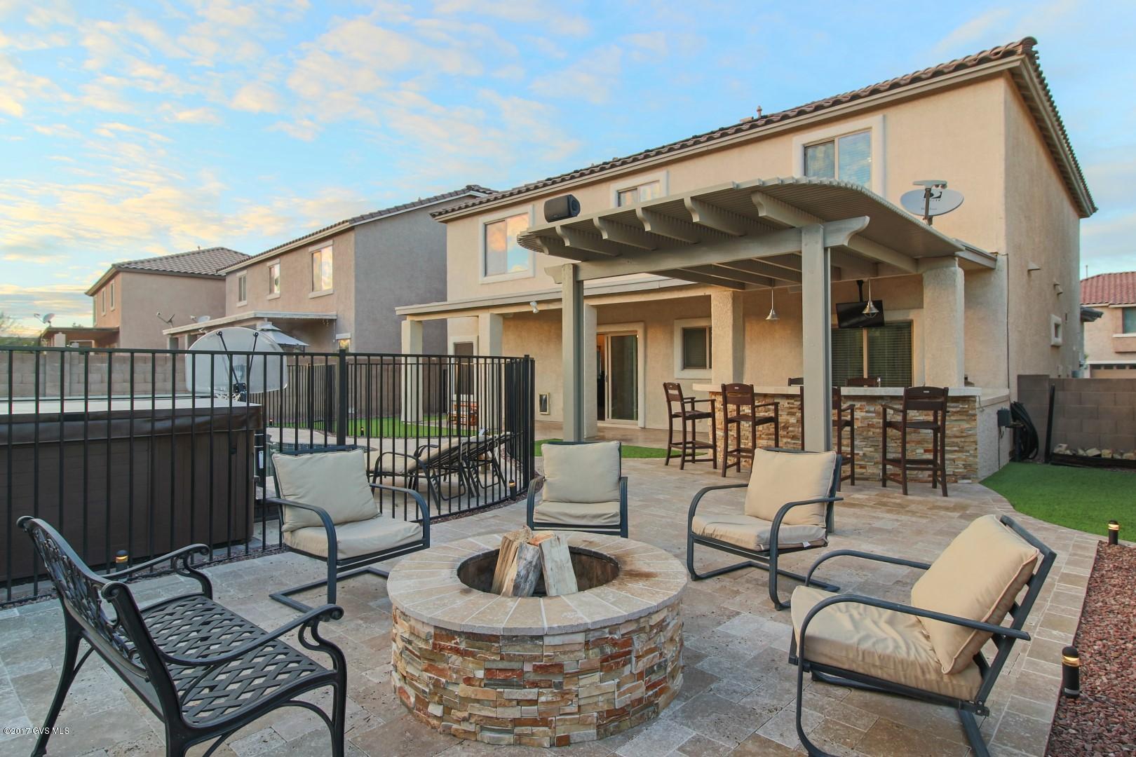 RESORT LIFESTYLE at it's BEST!! Enter into a stunning living room with gorgeous dark ceramic wood look tile planks - continue as the room opens into the dining room and kitchen. Plenty of room to entertain indoors and outdoors - surround system creates the perfect ambiance. Enjoy your OASIS of travertine pavers, faux grass, above ground spa for six, wood burning fire pit and the solar heated pool (salt system) for year-round enjoyment. Outdoor kitchen features stone staked bar front, pergola for added shade, wall mounted TV and pendent lighting. Full bedroom and bathroom downstairs for guest. Upstairs loft has rubberized gym flooring with mirrors to create your private gym; the adjacent area is carpeted - kick back and enjoy a movie. All upstairs bedrooms are spacious with walk in  closets designed by California Closets. This home is a MUST SEE...too many features to mention!! |\n|Don't forget the added amenities of the Award Winning Community of Rancho Sahuarita, nine parks, three large pools with picnic areas, splash park, mini golf course, ball courts, lake and many trails. Make this your forever home.