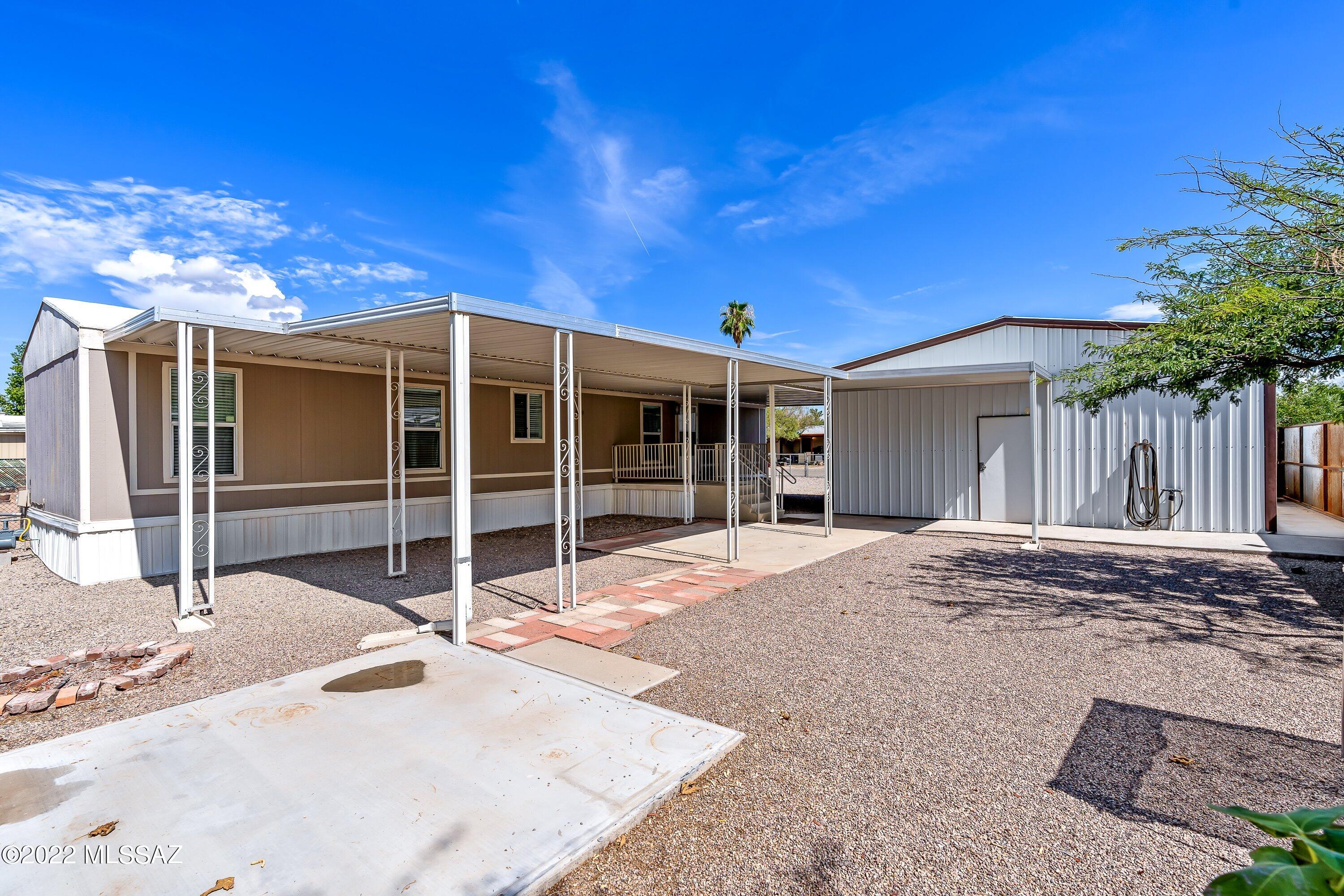 Fantastic opportunity to live in the award winning Flowing Wells School District! This home has had a lot of upgrades in the last two years to include: New AC unit, new instant water heater, metal 24x30 garage, concrete driveway, metal fencing on the east side and around the garage, new laminate flooring and floor plan modified to have two master suites. Flexible MU zoning leaves you lots of options on how you can use this property.