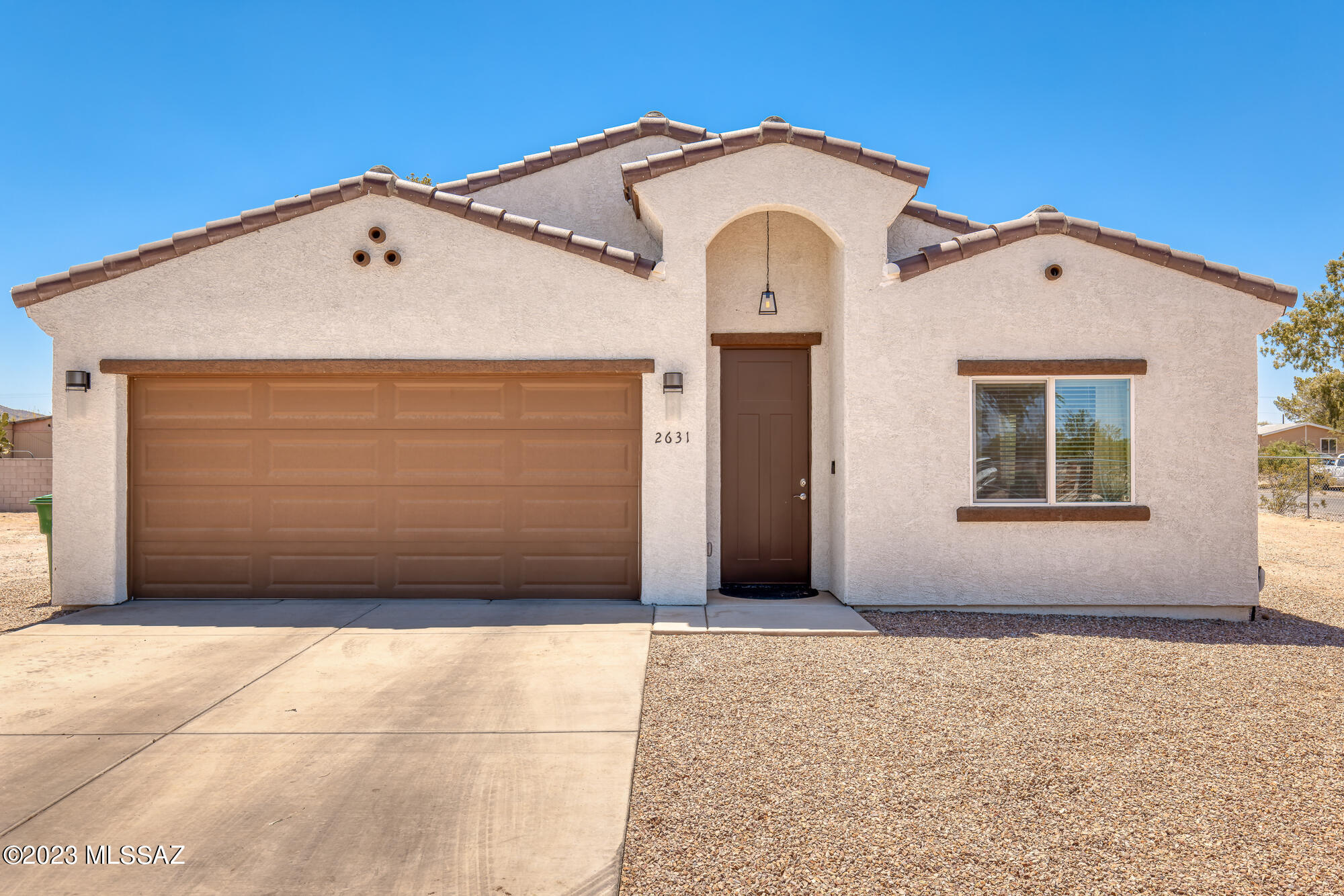 Welcome to this stunning 2022-built home situated on over 1 acre of land. This spacious property boasts 4 bedrooms and 2 bathrooms, providing ample space for comfortable living. As you enter, you'll be greeted by a bright and open floor plan that seamlessly connects the living spaces. The kitchen features modern appliances, ample counter space, and an abundance of cabinets for all your storage needs. It's the perfect place to whip up delicious meals while entertaining family and friends. The primary bedroom is a true retreat with dual vanities, allowing for simultaneous use, and a beautifully tiled shower. His and hers closets provide plenty of space for your wardrobe, ensuring organization and convenience. This property offers not one, but two garages -a convenient attached garage for easy access to the main living area and an additional detached garage that provides extra space for parking or storage. The expansive backyard provides endless possibilities for outdoor activities, gardening, or creating your own private oasis. The block wall recently added west of the home gives you the privacy you need to enjoy your backyard. This home is close to shopping and amenities for the whole family to enjoy! Don't miss the opportunity to make this 2022-built home yours.